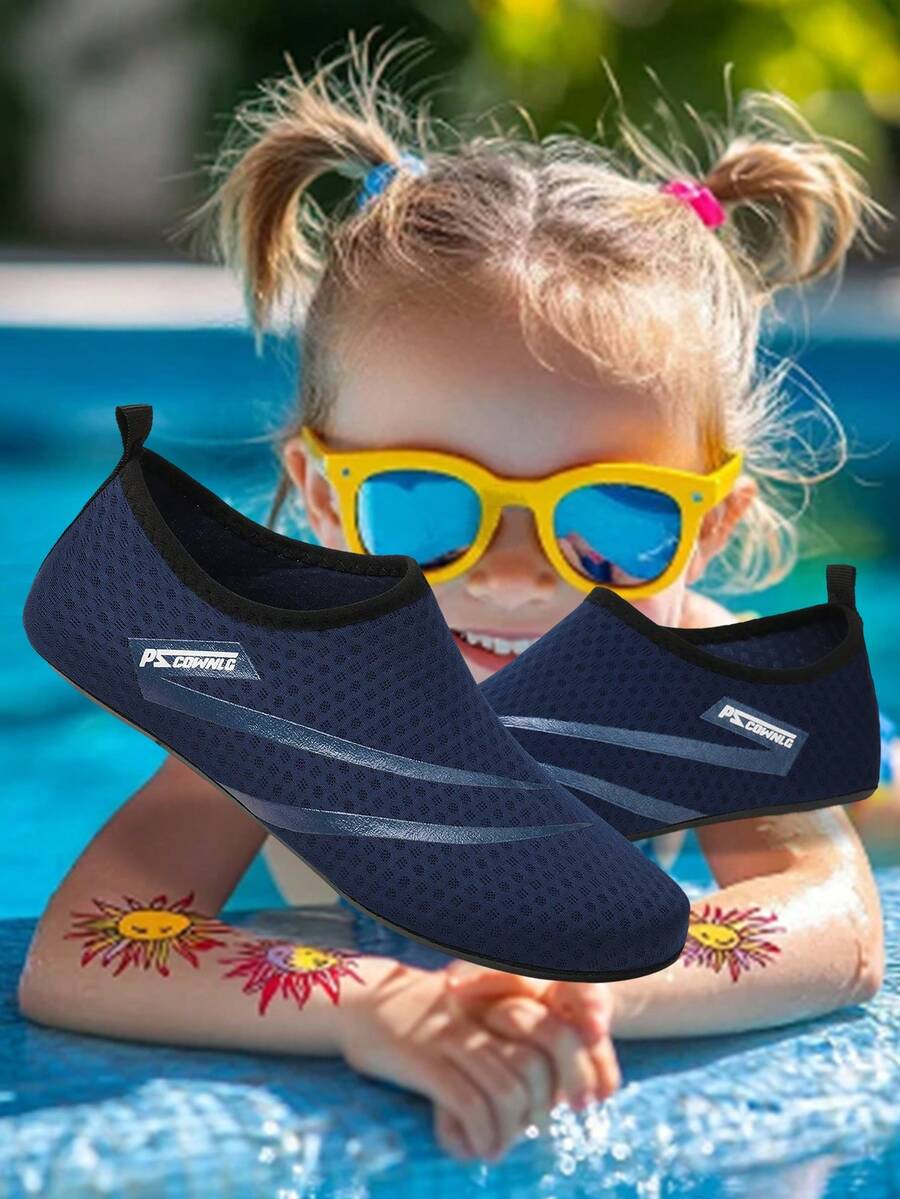 Black slip-on kids water shoes with a graphic pattern fabric upper and wear-resistant rubber outsole for boys and girls.