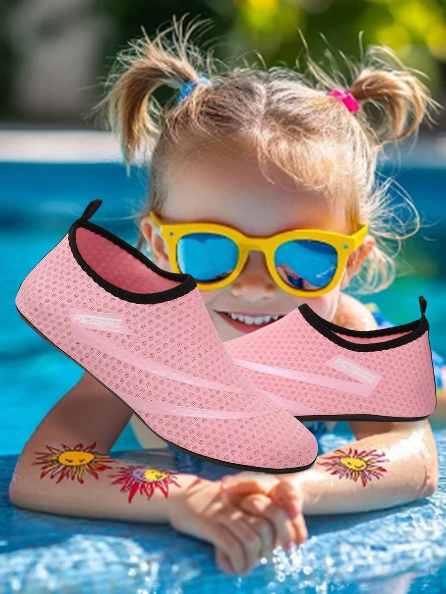 Black slip-on kids water shoes with a graphic pattern fabric upper and wear-resistant rubber outsole for boys and girls.