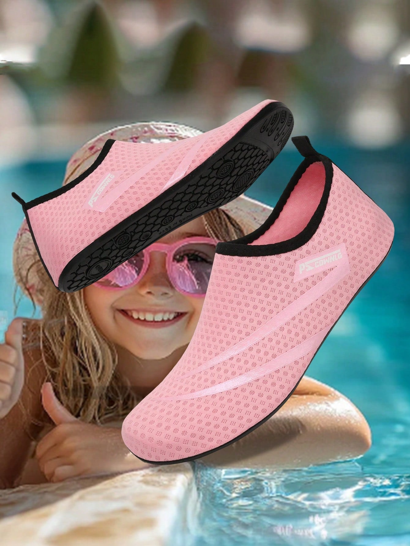 Black slip-on kids water shoes with a graphic pattern fabric upper and wear-resistant rubber outsole for boys and girls.