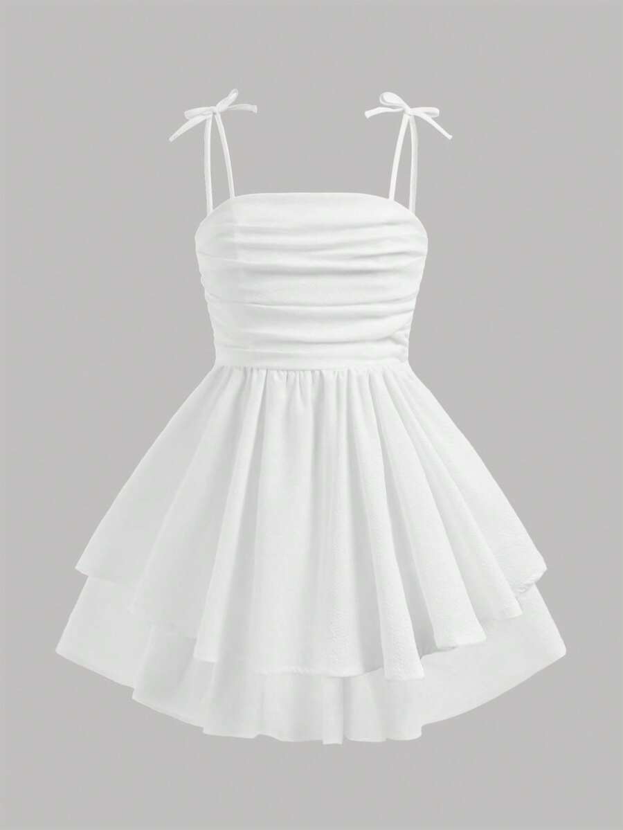 Tween girls apricot tiered cami dress with spaghetti straps, high waist, and slim fit layered hem.