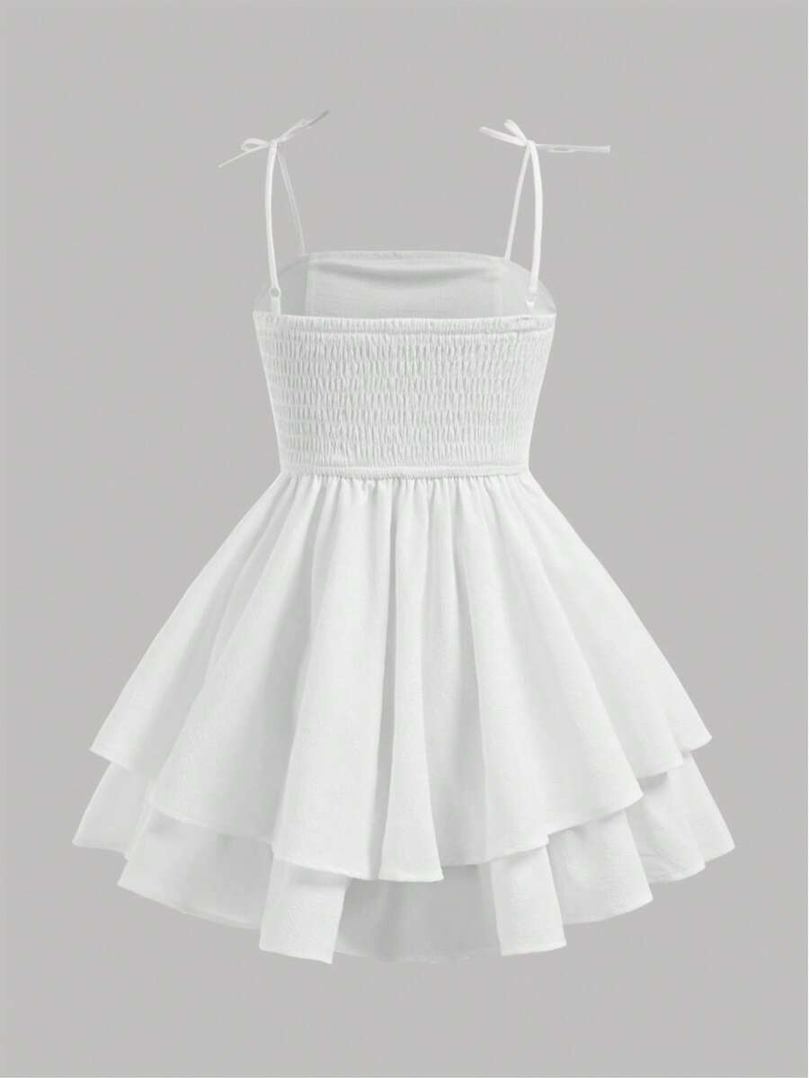 Tween girls apricot tiered cami dress with spaghetti straps, high waist, and slim fit layered hem.