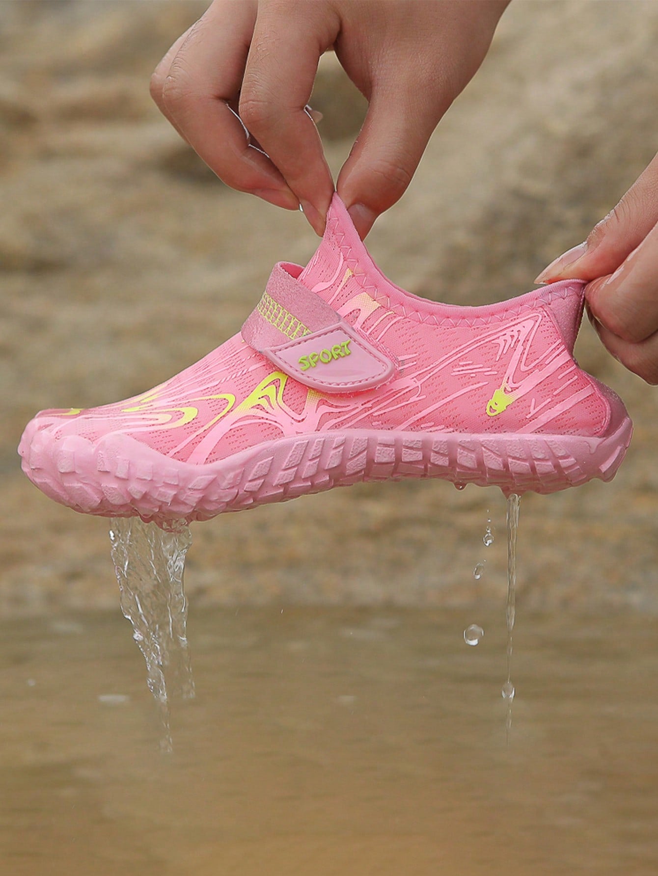 Children's water shoes featuring a breathable mesh upper, hook and loop closure, luminous details, and a non-slip outsole for boys and girls.