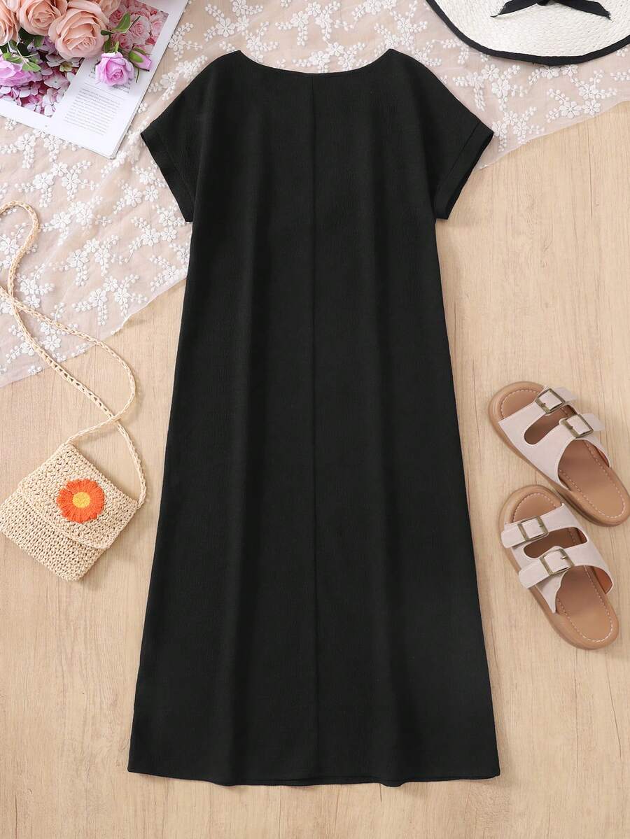 Tween girls casual black A-line long dress featuring short sleeves, a round neckline, and a decorative front bow with contrast lace trim.