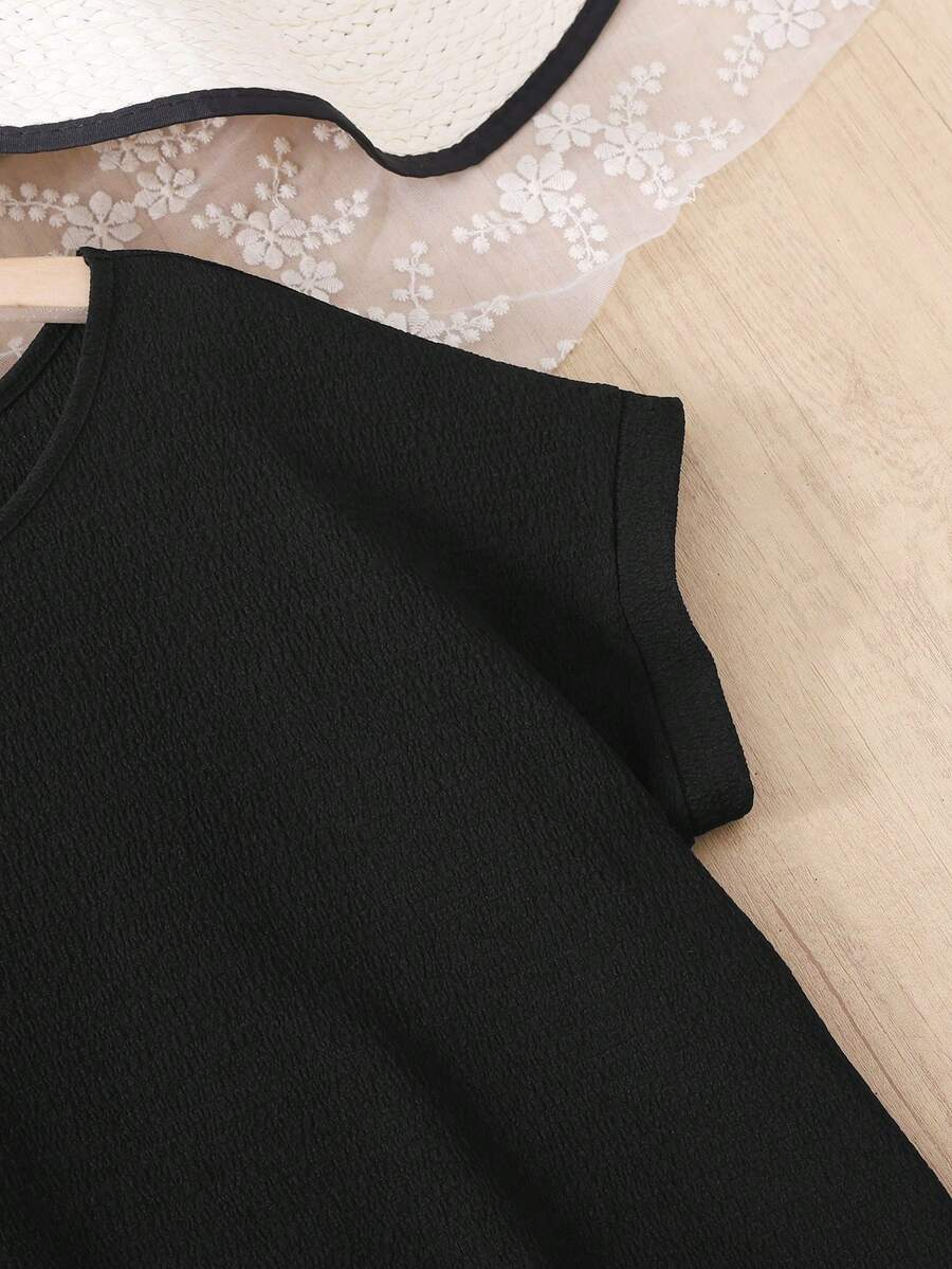 Tween girls casual black A-line long dress featuring short sleeves, a round neckline, and a decorative front bow with contrast lace trim.