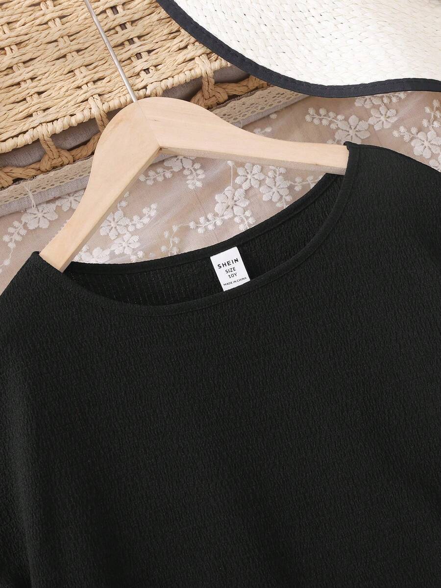 Tween girls casual black A-line long dress featuring short sleeves, a round neckline, and a decorative front bow with contrast lace trim.