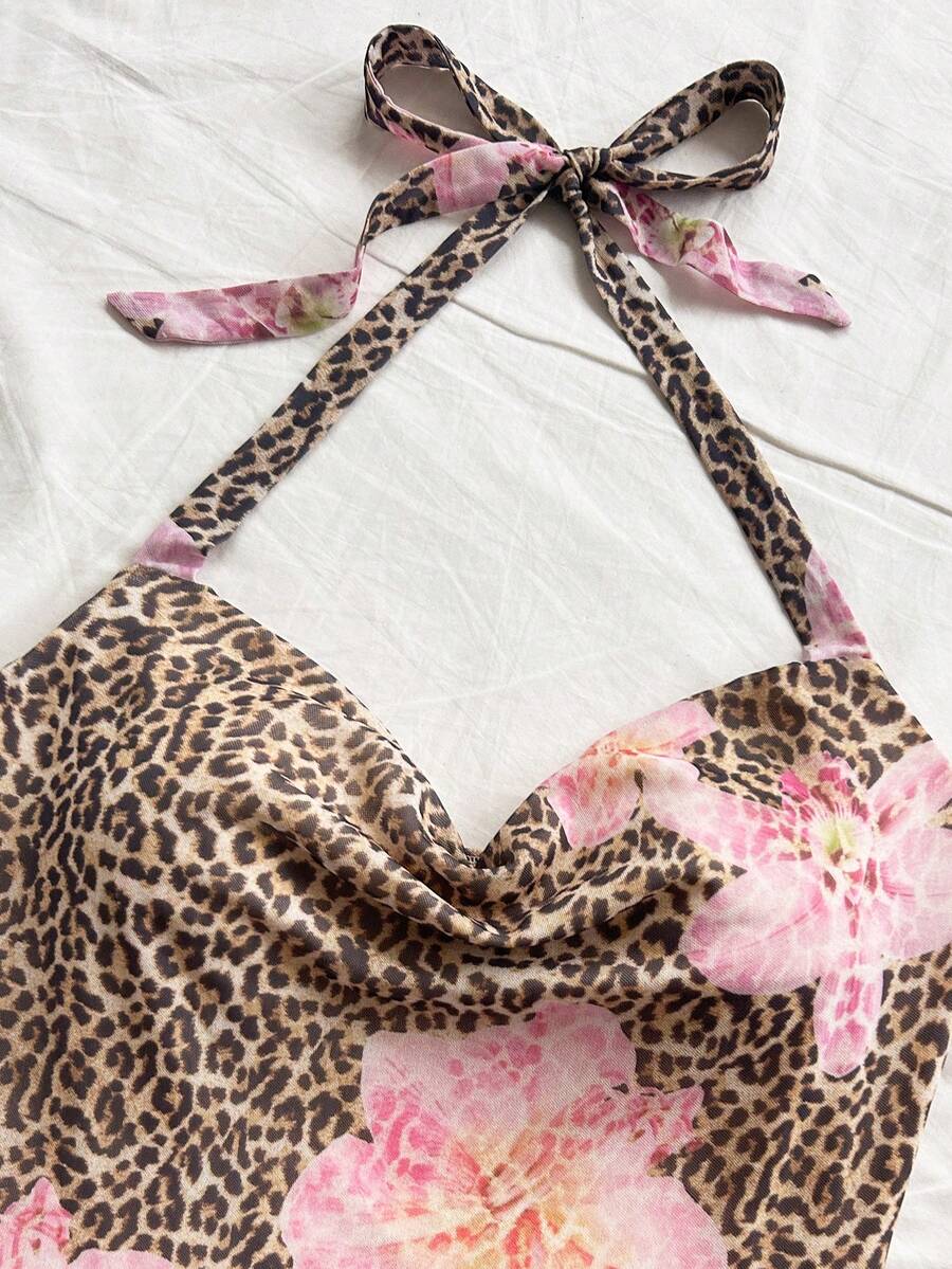 Tween girls sleeveless halter mini dress with ruffle tiered details, flounce hem, slim fit, lined body, and vacation-inspired plant print in khaki and pink tones.