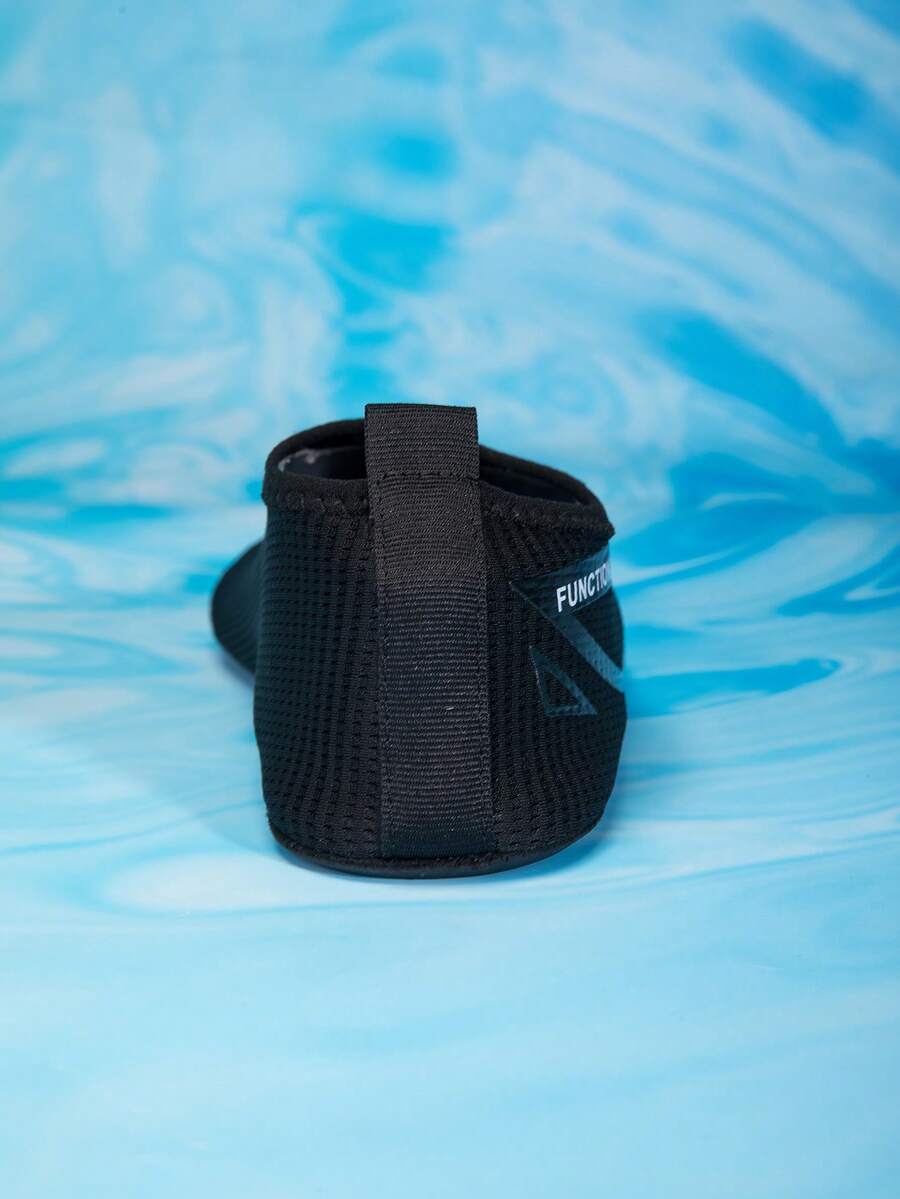 Kids black slip-on water shoes featuring a breathable mesh upper and durable rubber outsole for boys and girls.