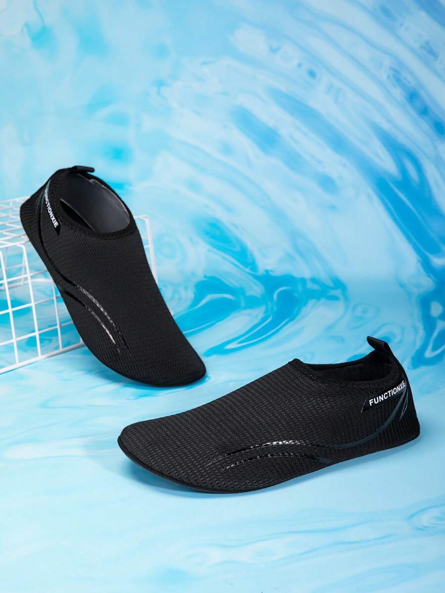 Kids black slip-on water shoes featuring a breathable mesh upper and durable rubber outsole for boys and girls.