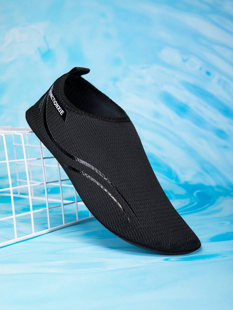 Kids black slip-on water shoes featuring a breathable mesh upper and durable rubber outsole for boys and girls.