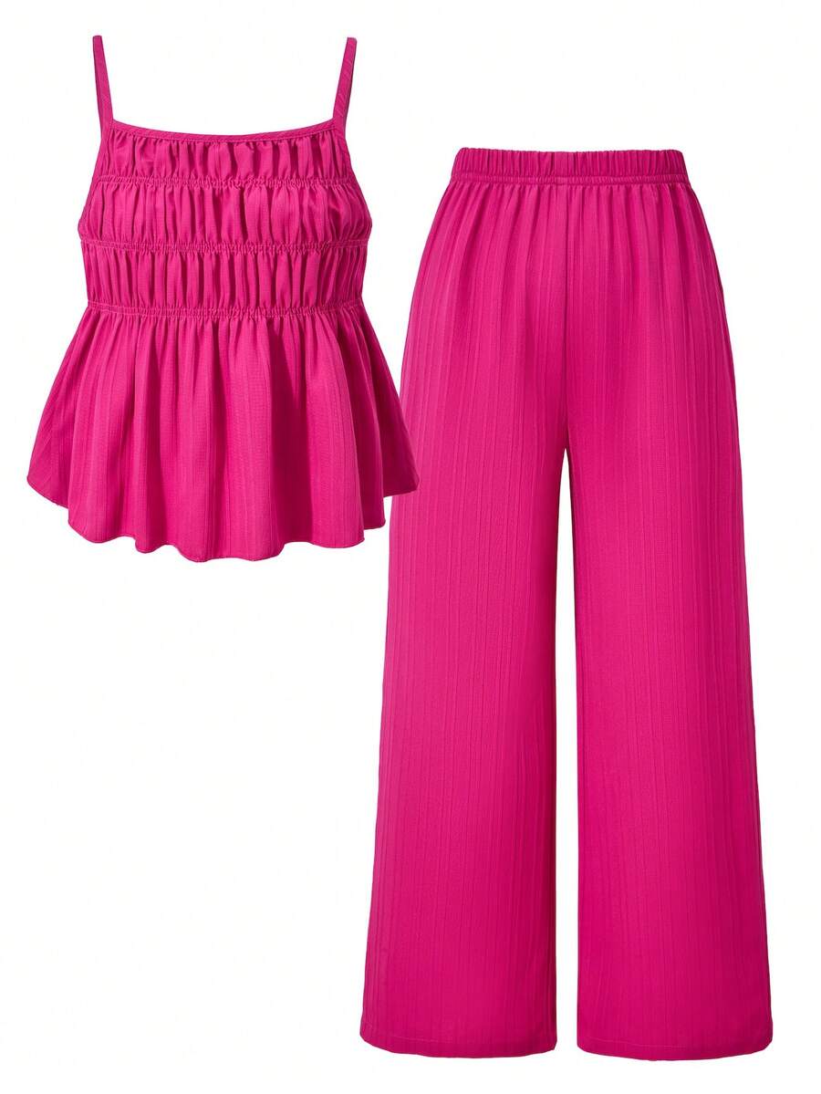Tween girl wearing an apricot 2-piece outfit set featuring a shirred spaghetti strap short cami top and matching wide-leg long pants.