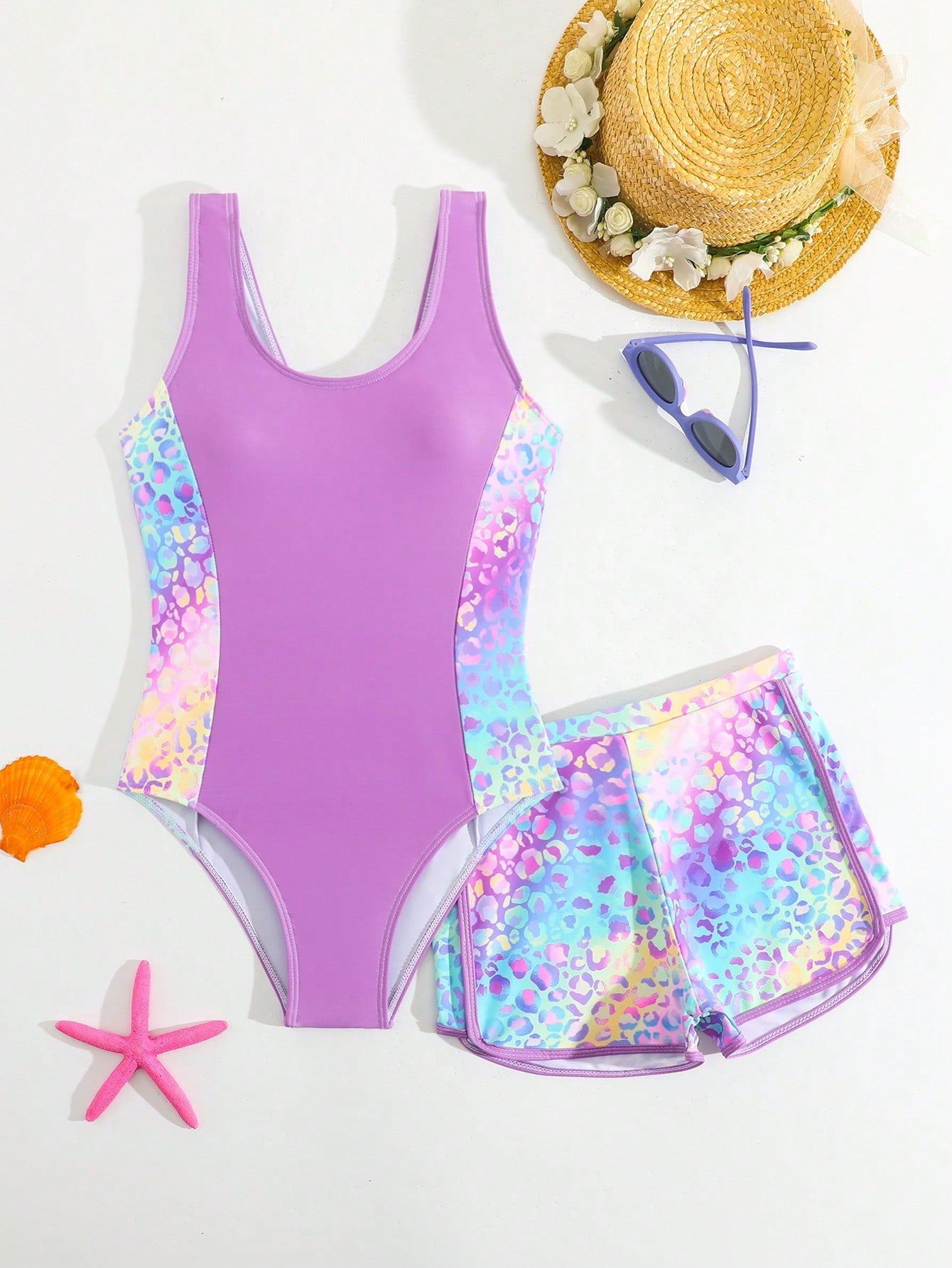 Tween girls 2-piece swimsuit set with a printed one-piece featuring ruffle trim, scoop neckline, cut-out detail, and matching shorts bottom.