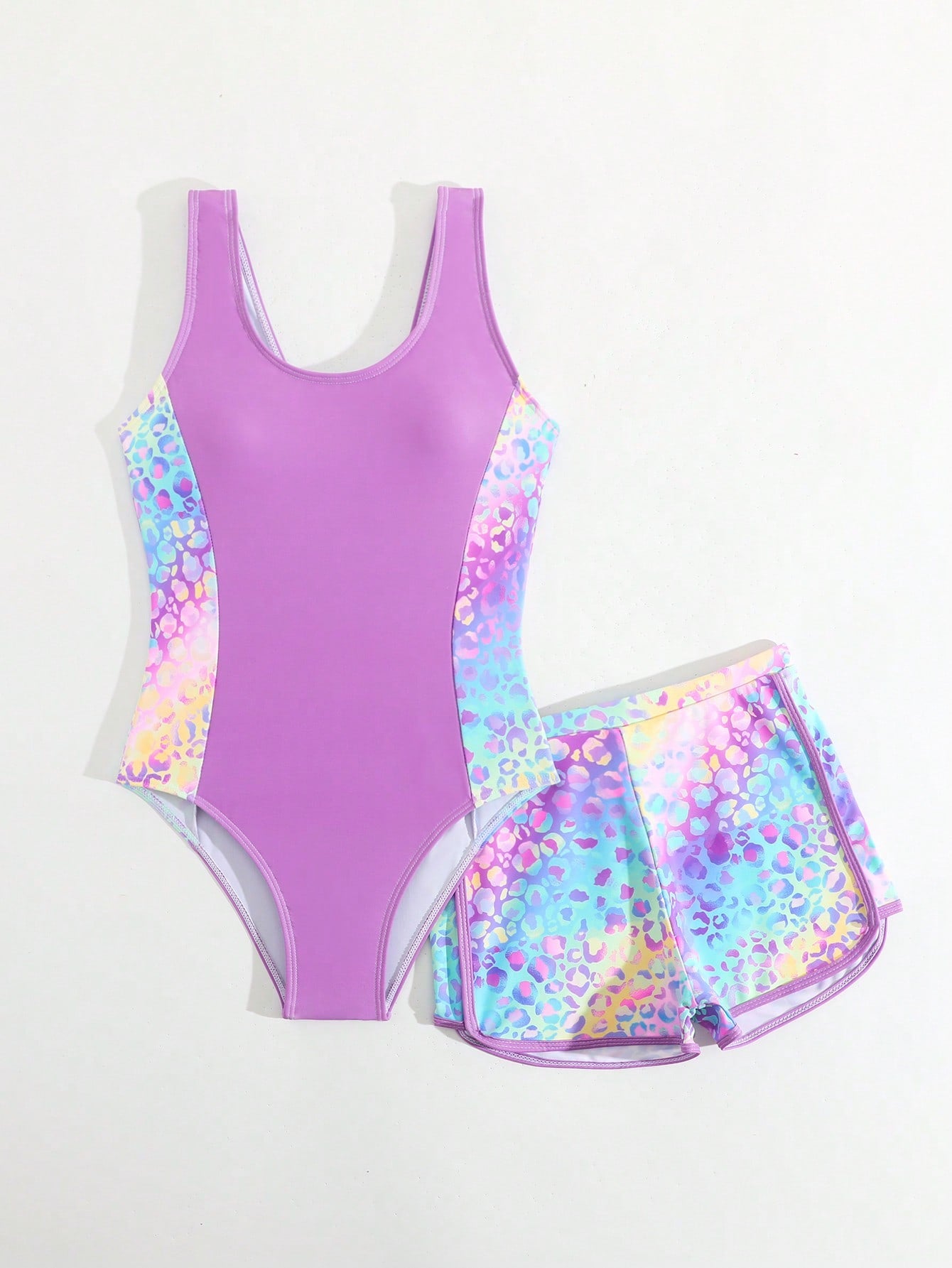 Tween girls 2-piece swimsuit set with a printed one-piece featuring ruffle trim, scoop neckline, cut-out detail, and matching shorts bottom.