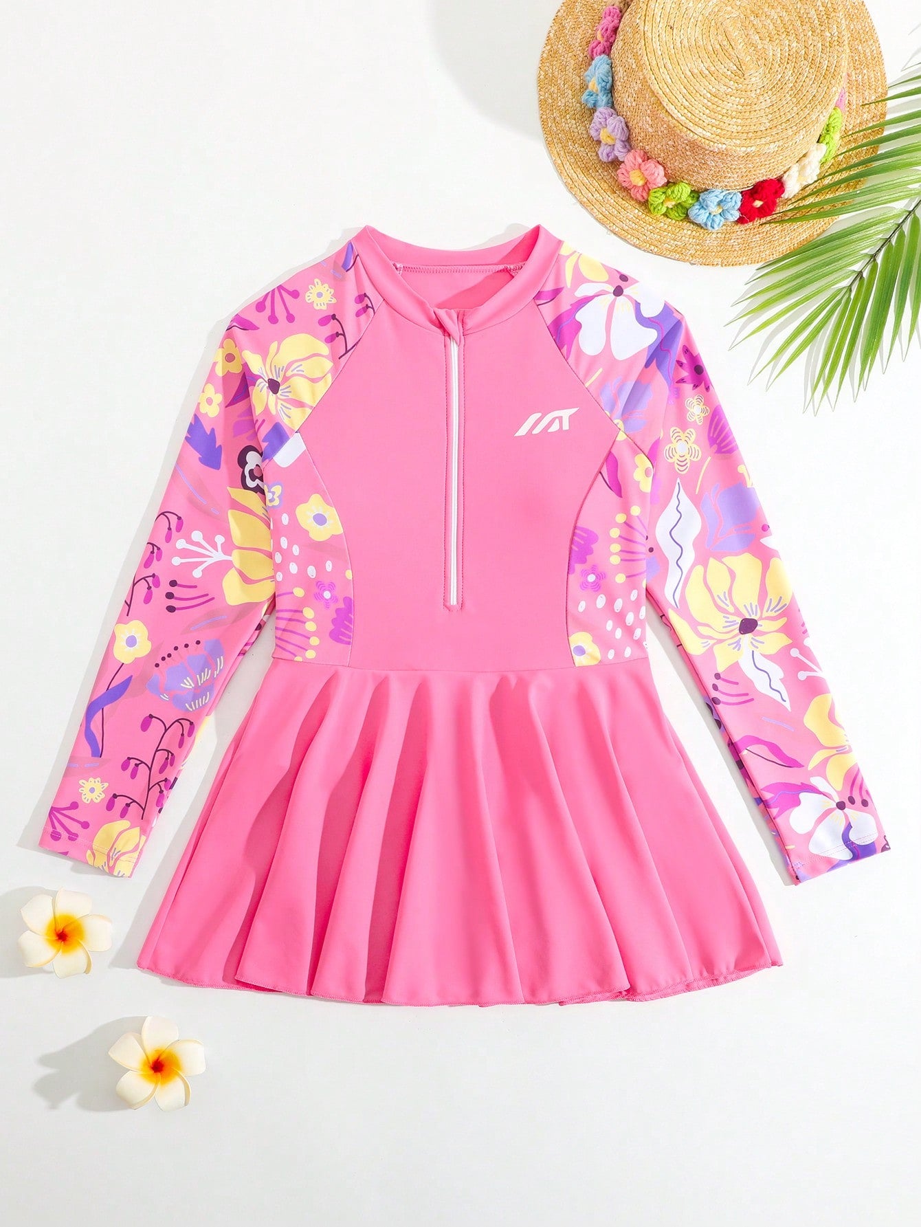 Tween girls one-piece swimsuit in black floral pattern with long sleeves, high neck, front zipper, and a skirt-style bottom.