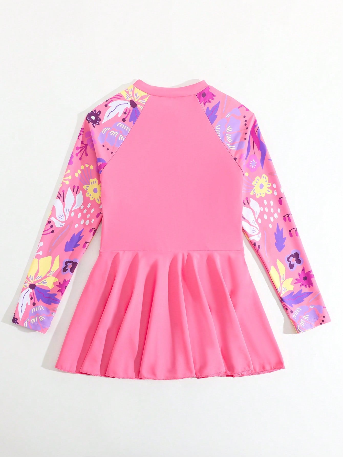 Tween girls one-piece swimsuit in black floral pattern with long sleeves, high neck, front zipper, and a skirt-style bottom.