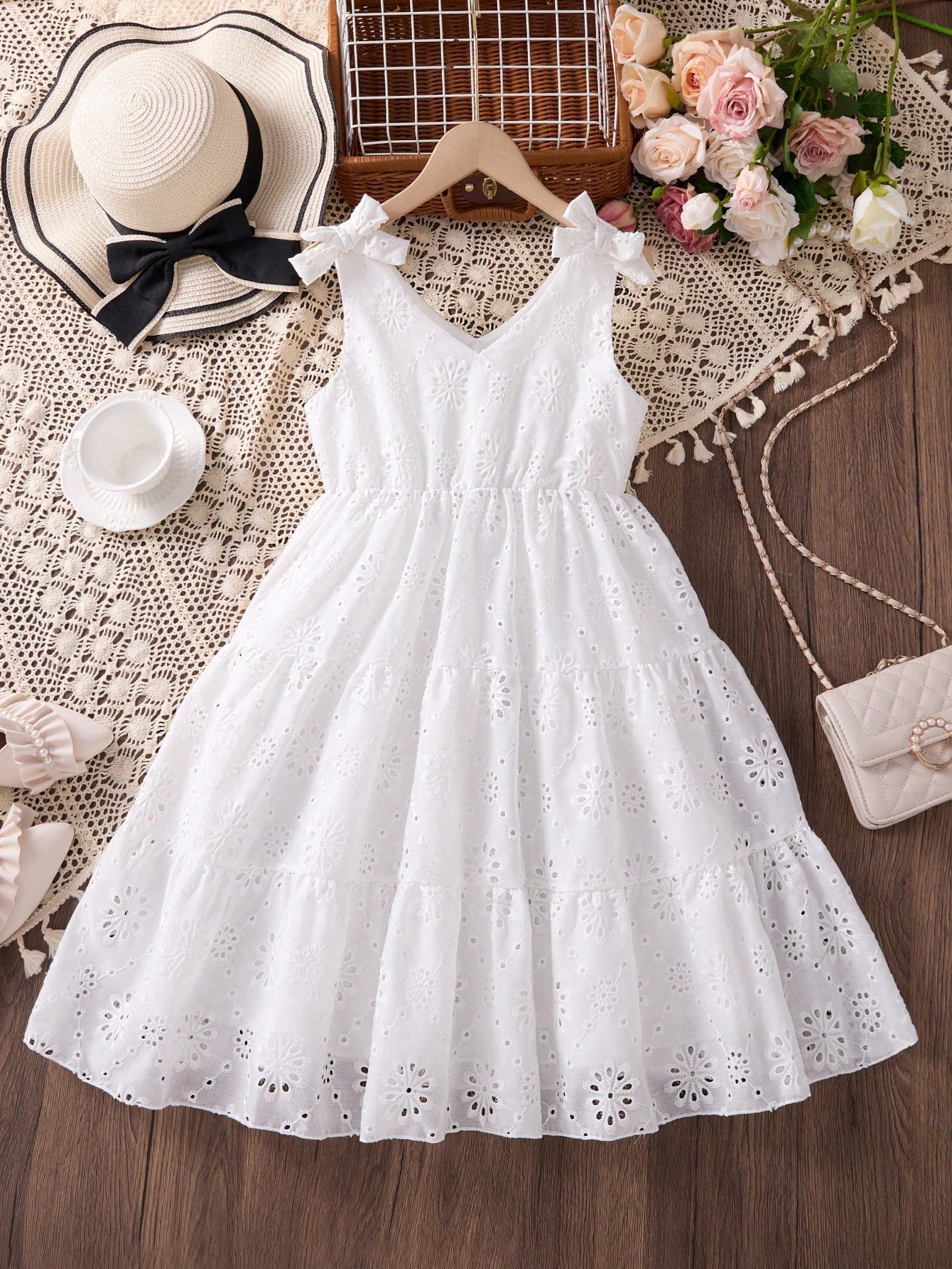 Girls sleeveless blue tiered dress featuring a V-neckline, high waist, and A-line skirt.