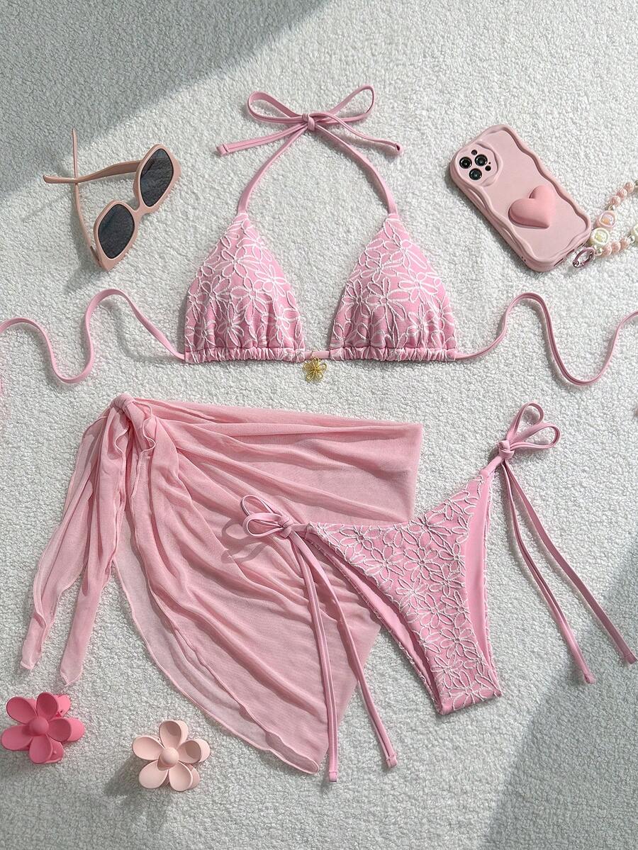 Women's 3-piece blue tropical shell print bikini set featuring a halter bralette top, low-waist tie-side bottom, and a matching sheer mesh cover-up skirt.