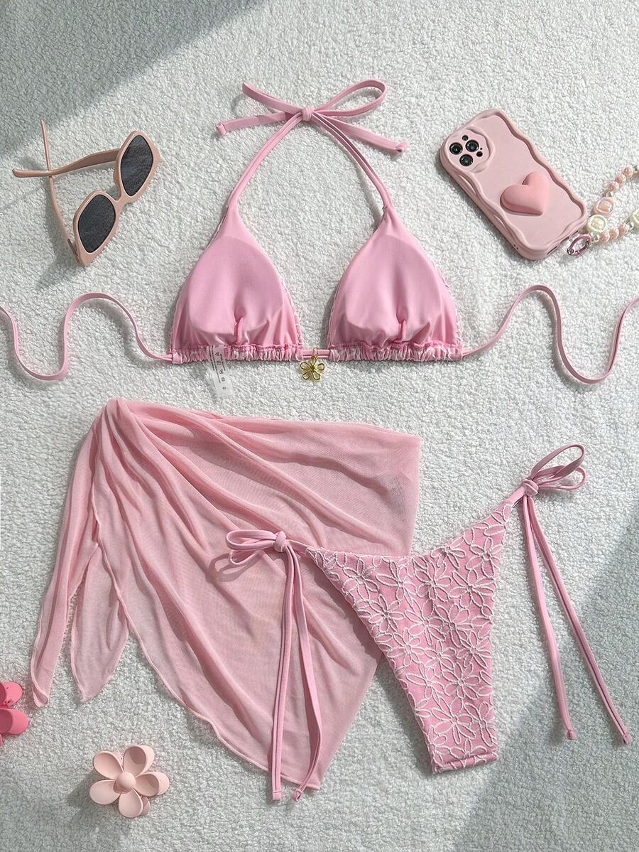 Women's 3-piece blue tropical shell print bikini set featuring a halter bralette top, low-waist tie-side bottom, and a matching sheer mesh cover-up skirt.