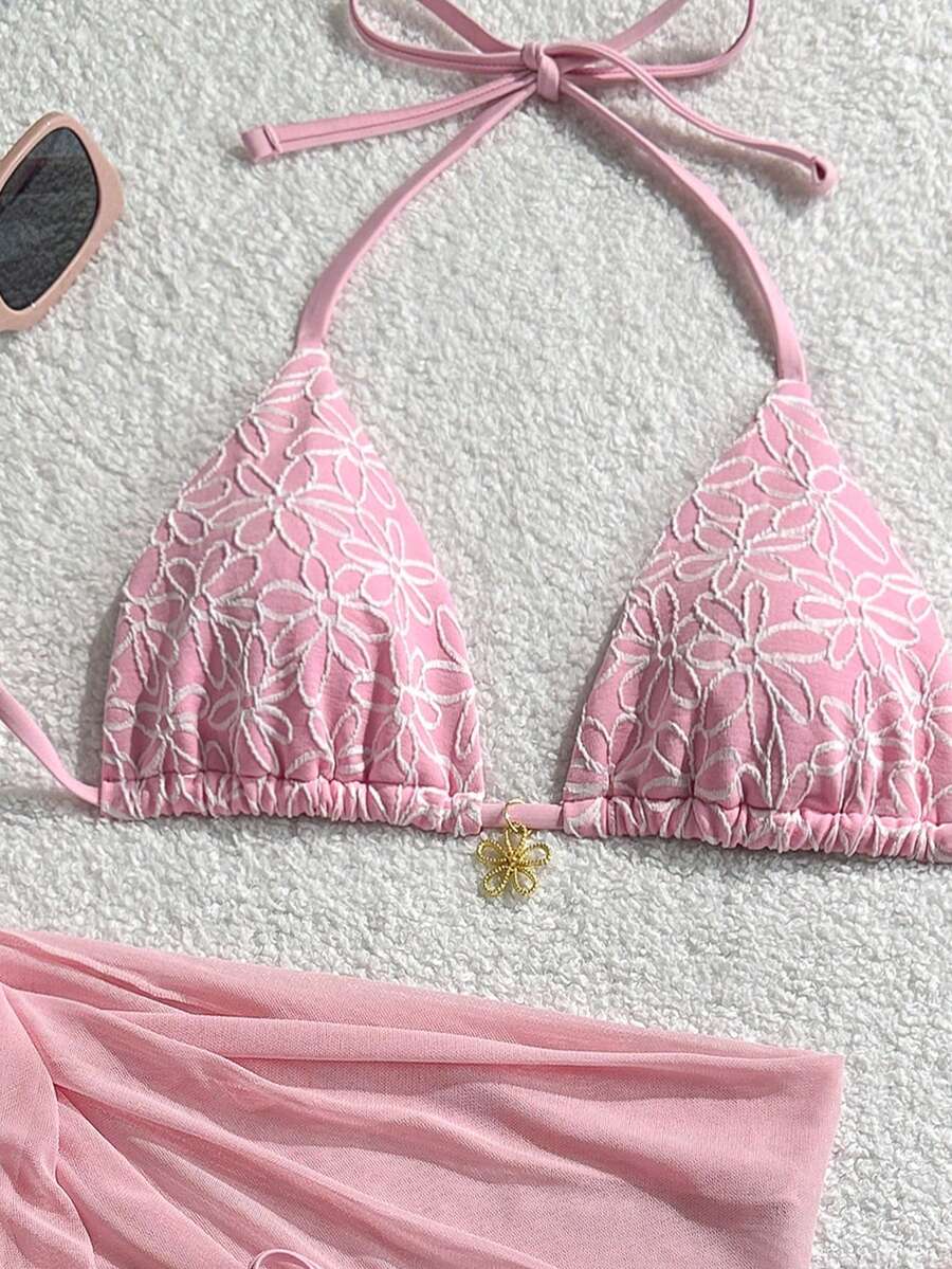 Women's 3-piece blue tropical shell print bikini set featuring a halter bralette top, low-waist tie-side bottom, and a matching sheer mesh cover-up skirt.