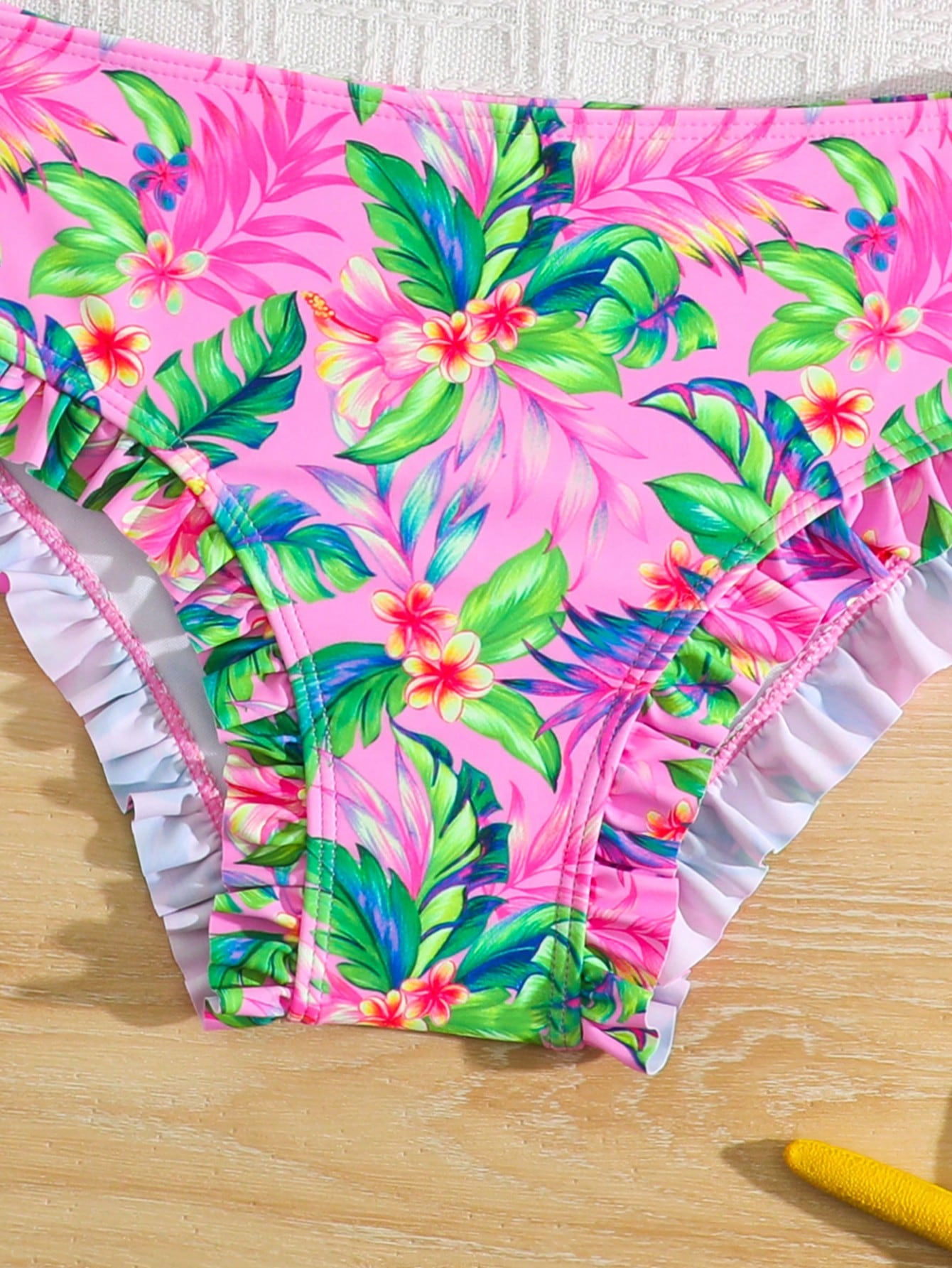 Tween girls solid color 2-piece bikini swimwear set with ruffle detail, strap neckline, wireless bikini top, and triangle mid-waist bikini bottoms; textured pattern with lined bottoms and high-stretch fabric, suitable for summer vacation.