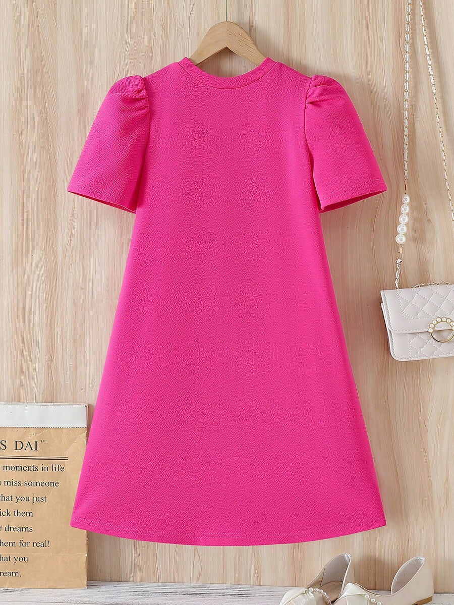 Tween girls apricot short-sleeve pleated smock dress with 3D bow decor and round neckline.