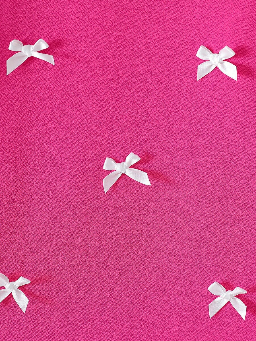 Tween girls apricot short-sleeve pleated smock dress with 3D bow decor and round neckline.