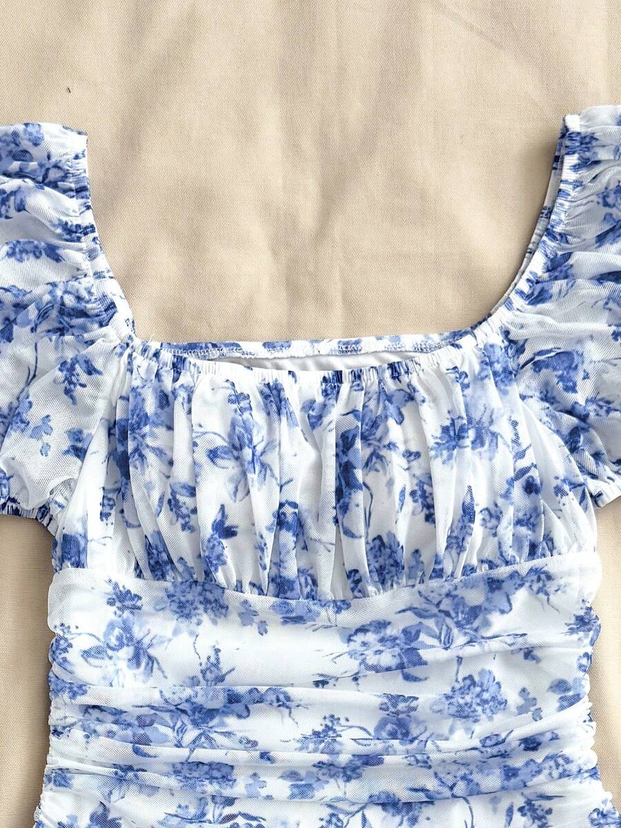 Teen girls red floral print A-line party dress featuring short puff sleeves, square neckline, ruched bust, and contrast lace details.