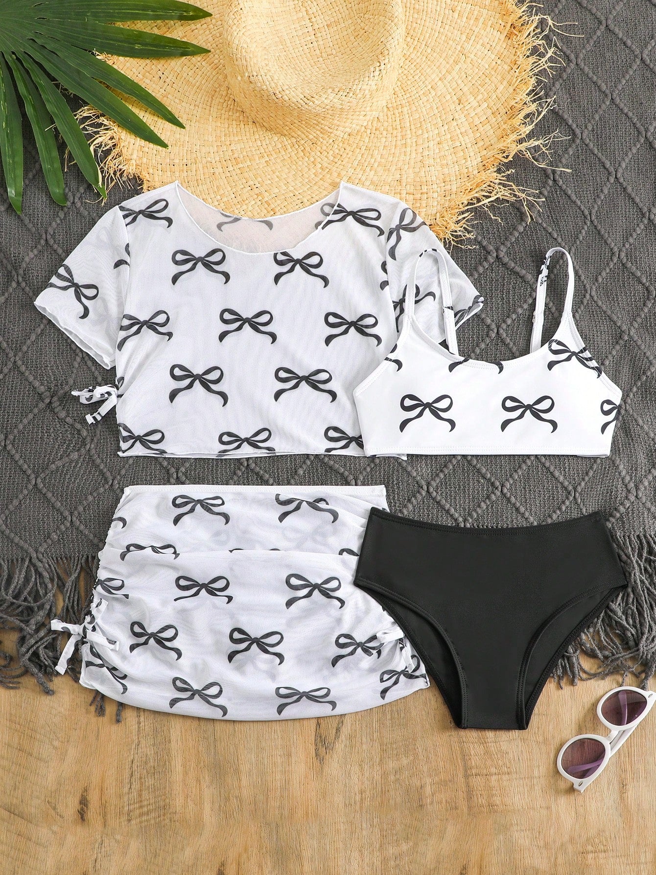 Tween girls 4-piece boho butterfly print bikini set in blue featuring spaghetti strap top, mid waist bottoms, and matching cover-up skirt.