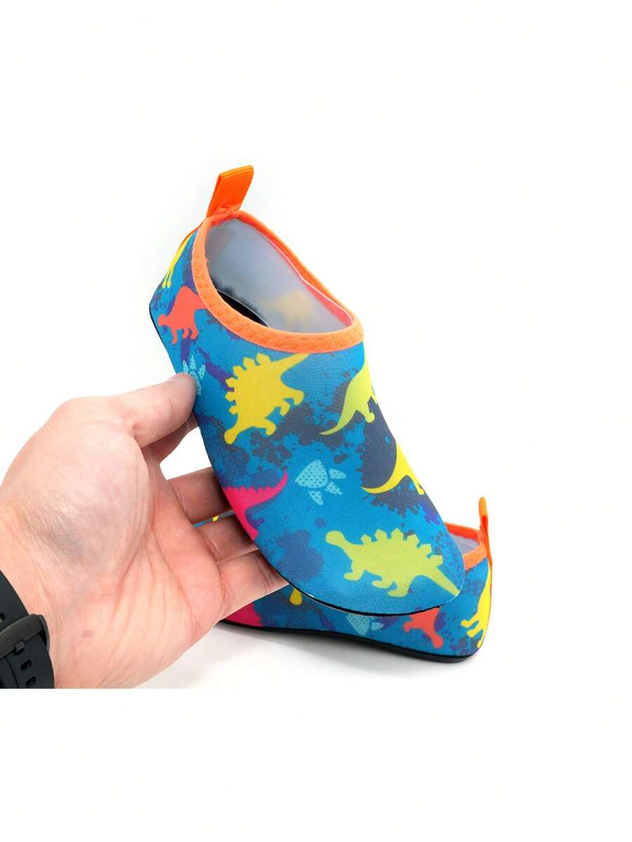 Multicolor cartoon dinosaur kids water shoes with breathable slip-on design and non-slip rubber outsole for boys.
