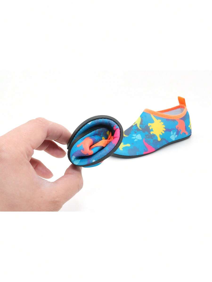 Multicolor cartoon dinosaur kids water shoes with breathable slip-on design and non-slip rubber outsole for boys.