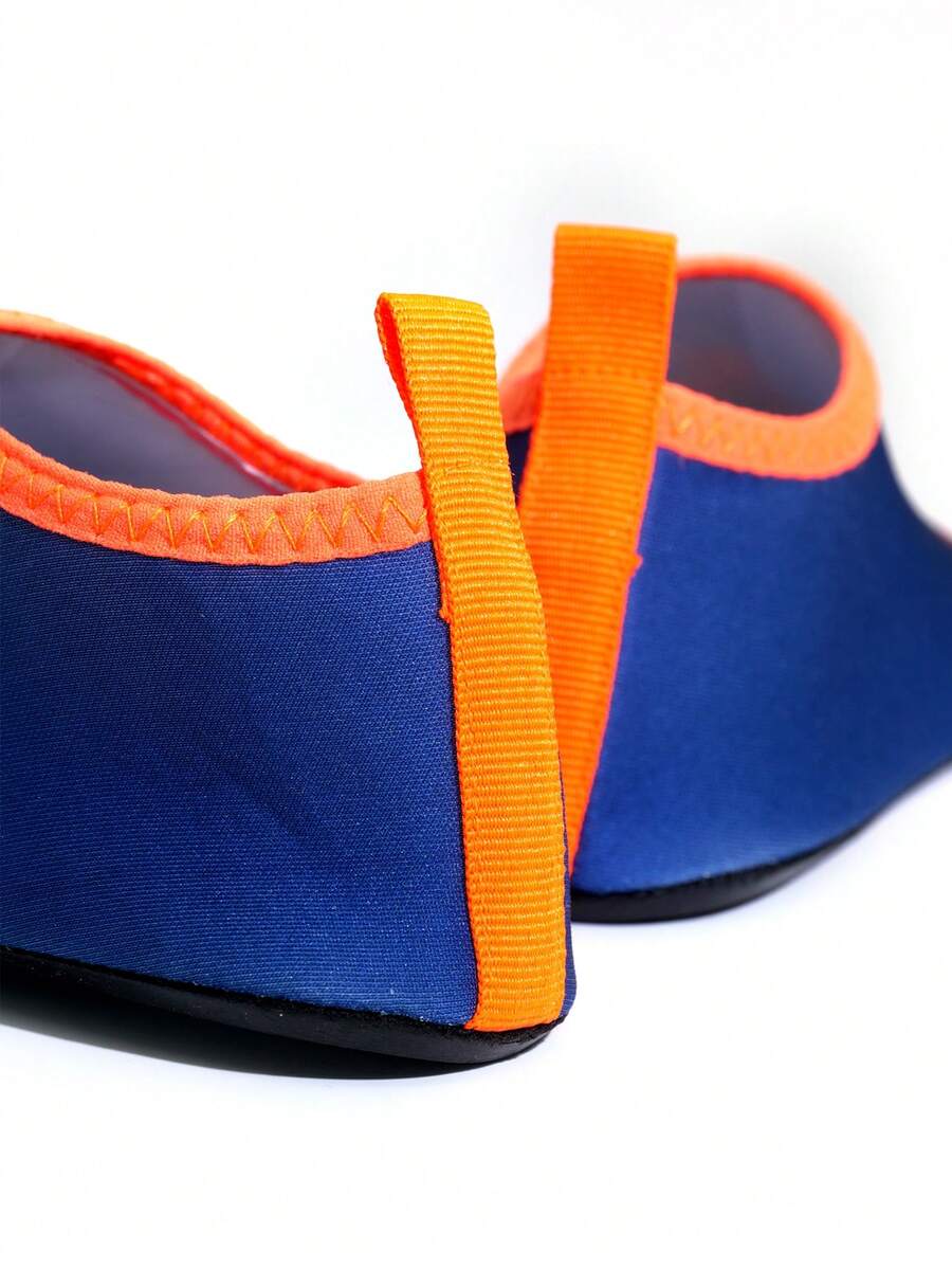 Multicolor cartoon dinosaur kids water shoes with breathable slip-on design and non-slip rubber outsole for boys.
