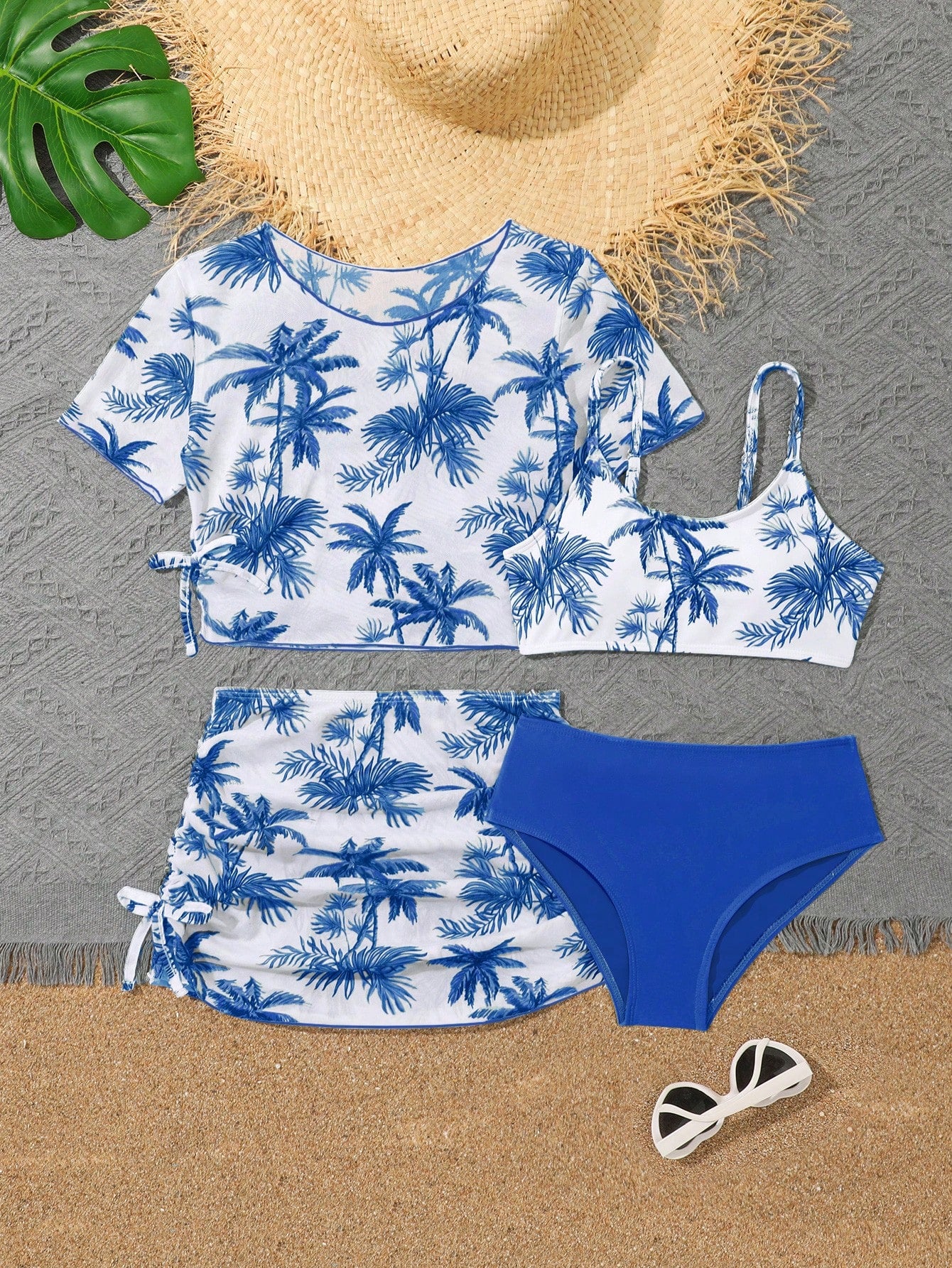 Tween girls 4-piece boho butterfly print bikini set in blue featuring spaghetti strap top, mid waist bottoms, and matching cover-up skirt.