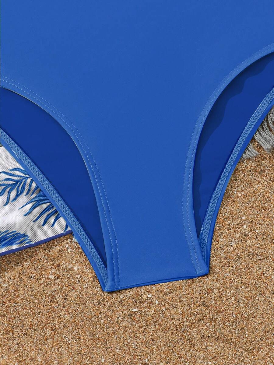 Tween girls 4-piece boho butterfly print bikini set in blue featuring spaghetti strap top, mid waist bottoms, and matching cover-up skirt.