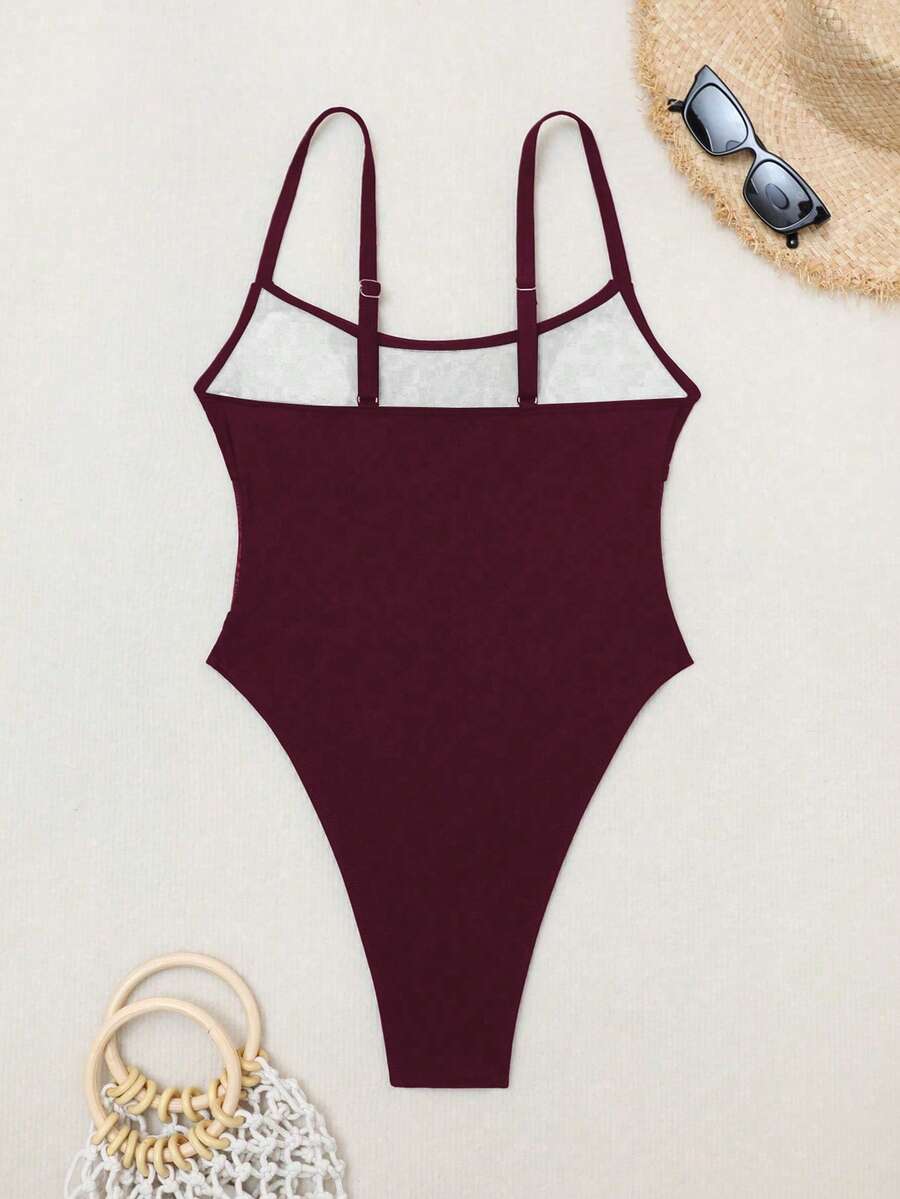 Black floral print mesh patchwork one-piece swimsuit for women featuring spaghetti straps, V-wired triangle cups, and a high waist silhouette.