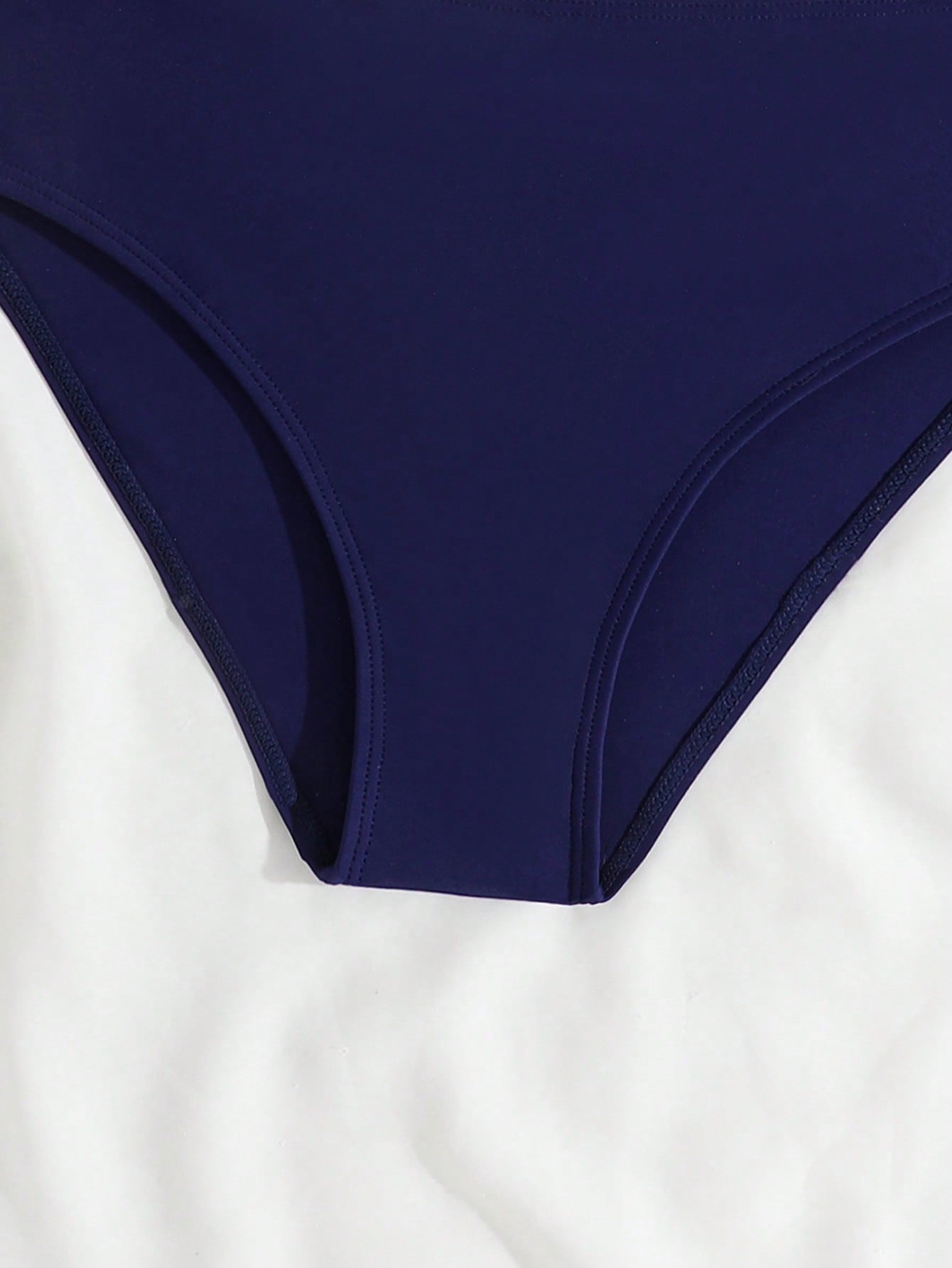 Blue tween girls bikini set with American flag and geometric print, featuring a sleeveless spaghetti strap wireless bikini top and high-waist bikini bottoms, suitable for summer beach vacation.
