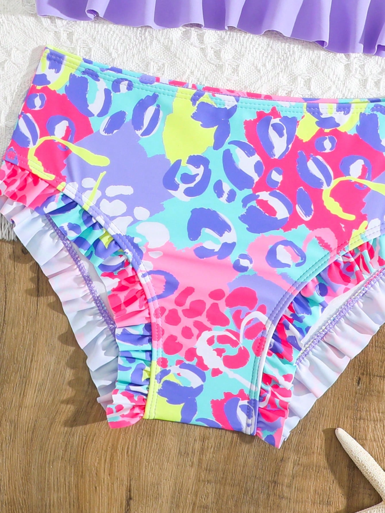 Tween girls solid color 2-piece bikini swimwear set with ruffle detail, strap neckline, wireless bikini top, and triangle mid-waist bikini bottoms; textured pattern with lined bottoms and high-stretch fabric, suitable for summer vacation.