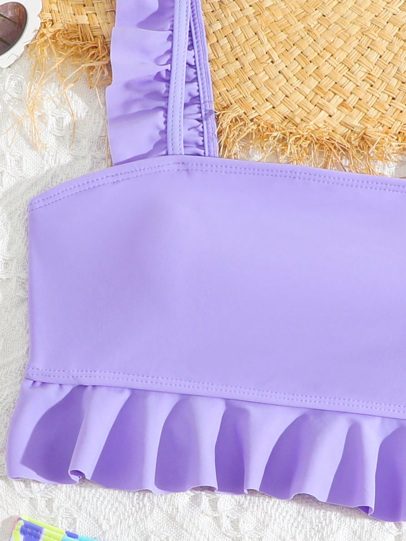 Tween girls solid color 2-piece bikini swimwear set with ruffle detail, strap neckline, wireless bikini top, and triangle mid-waist bikini bottoms; textured pattern with lined bottoms and high-stretch fabric, suitable for summer vacation.
