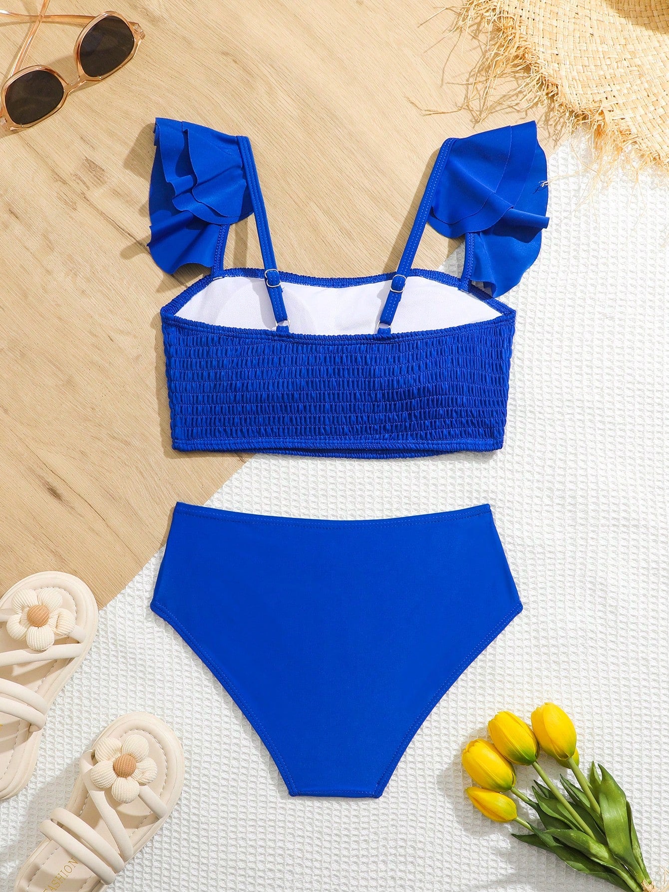 Tween girls tankini swimwear set with a solid color cap sleeve top featuring strap neckline and ruffle detail, paired with triangle-style briefs in a high-waist to mid-waist fit; two-piece vacation swim set.