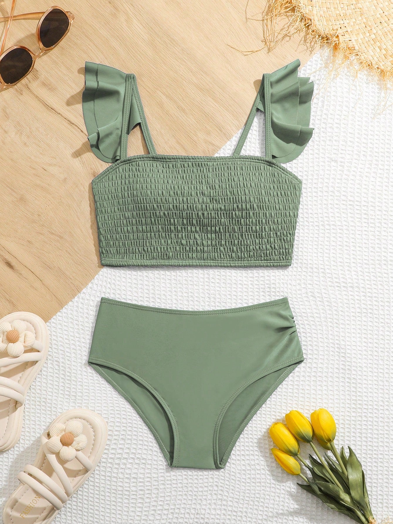 Tween girls tankini swimwear set with a solid color cap sleeve top featuring strap neckline and ruffle detail, paired with triangle-style briefs in a high-waist to mid-waist fit; two-piece vacation swim set.