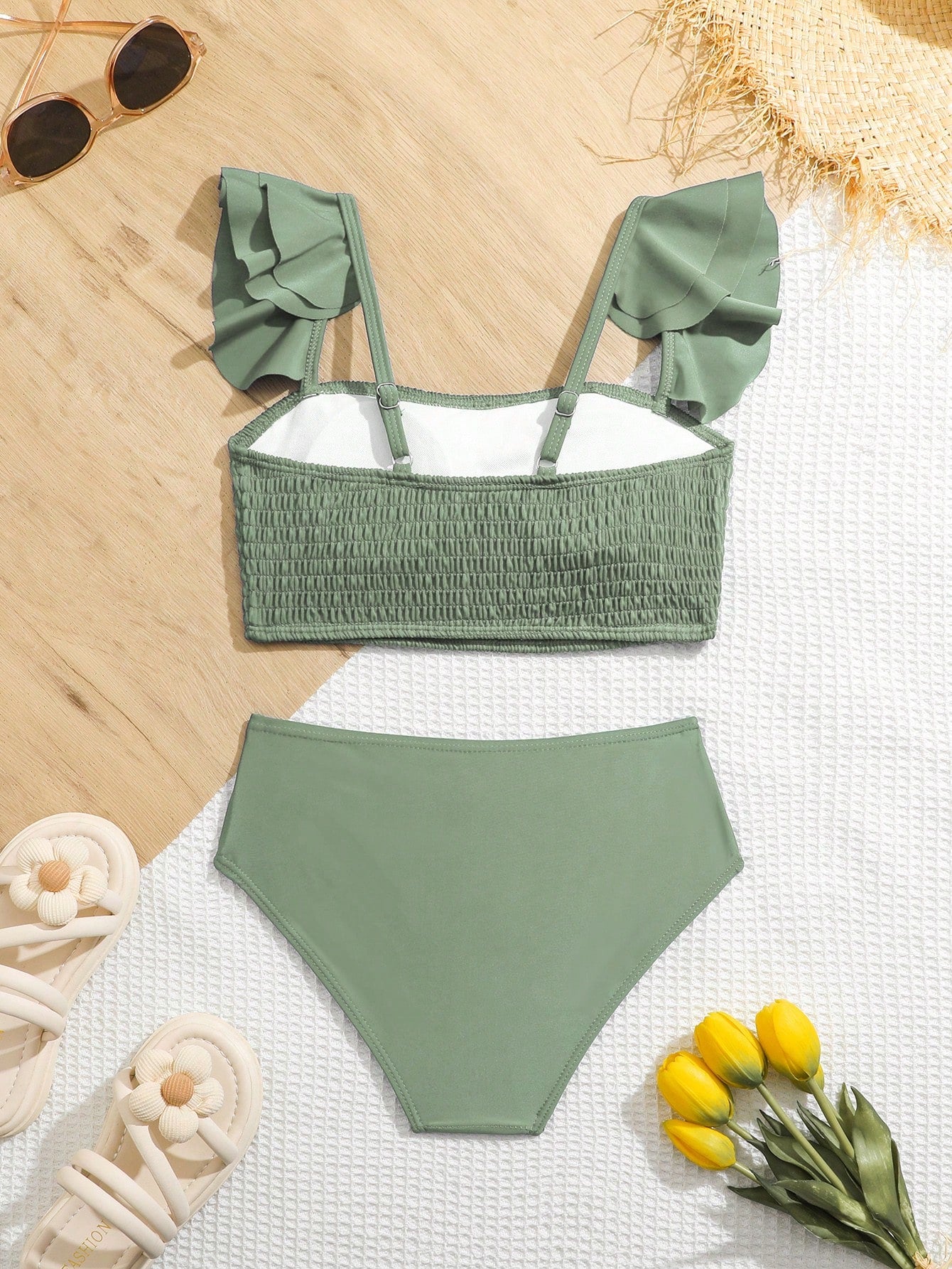Tween girls tankini swimwear set with a solid color cap sleeve top featuring strap neckline and ruffle detail, paired with triangle-style briefs in a high-waist to mid-waist fit; two-piece vacation swim set.