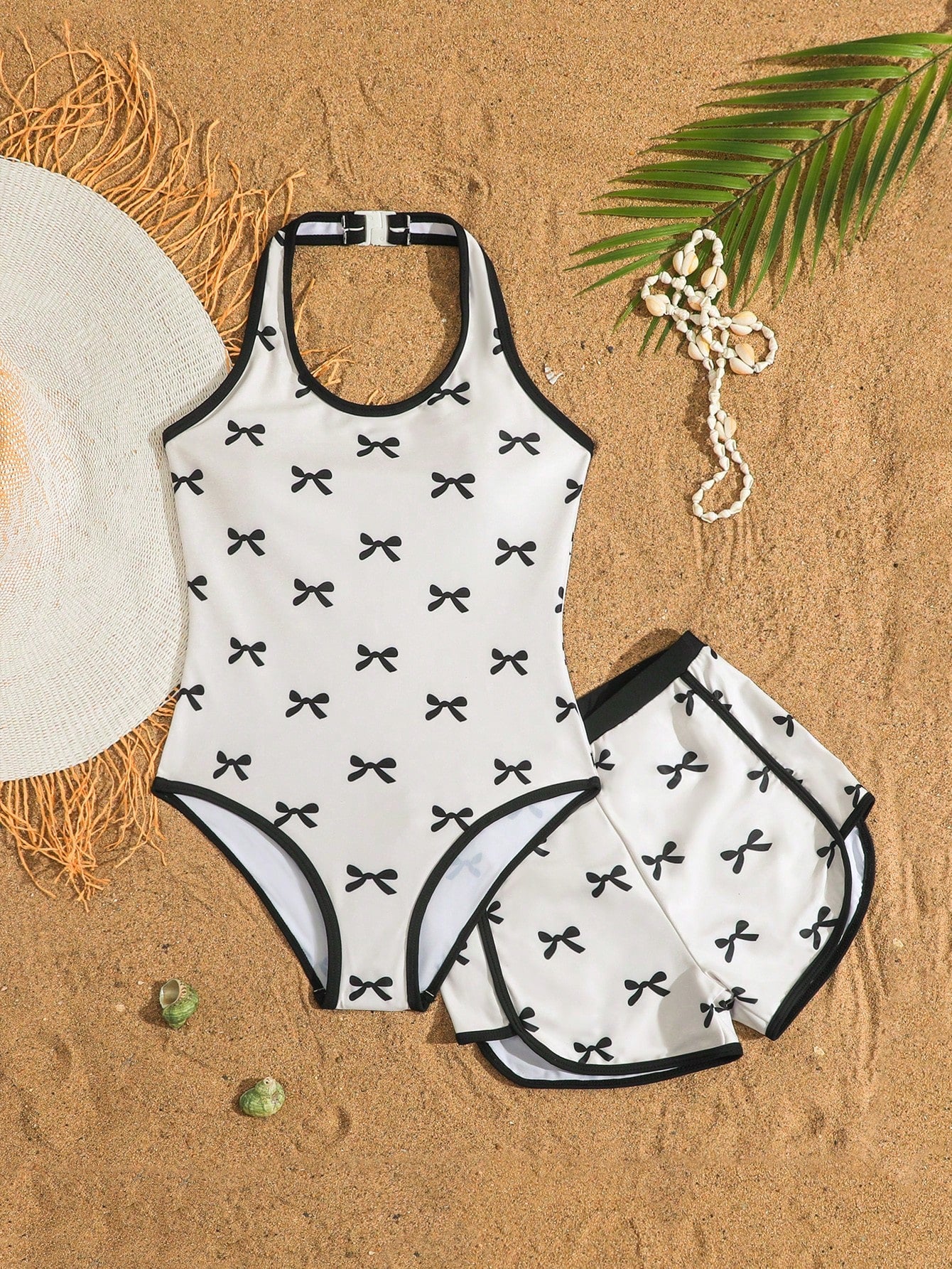 Girls 2-piece swimwear set featuring a butterfly print halter swimsuit top with contrast piping and separate mid-waist shorts; sleeveless, high-stretch, wireless design for beach and vacation wear.
