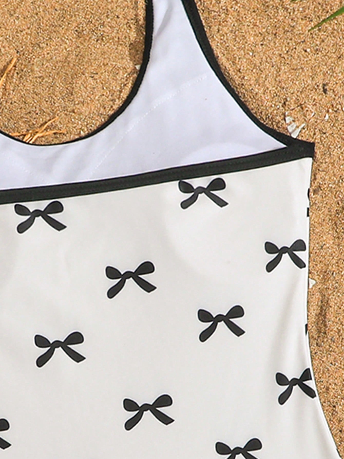 Girls 2-piece swimwear set featuring a butterfly print halter swimsuit top with contrast piping and separate mid-waist shorts; sleeveless, high-stretch, wireless design for beach and vacation wear.