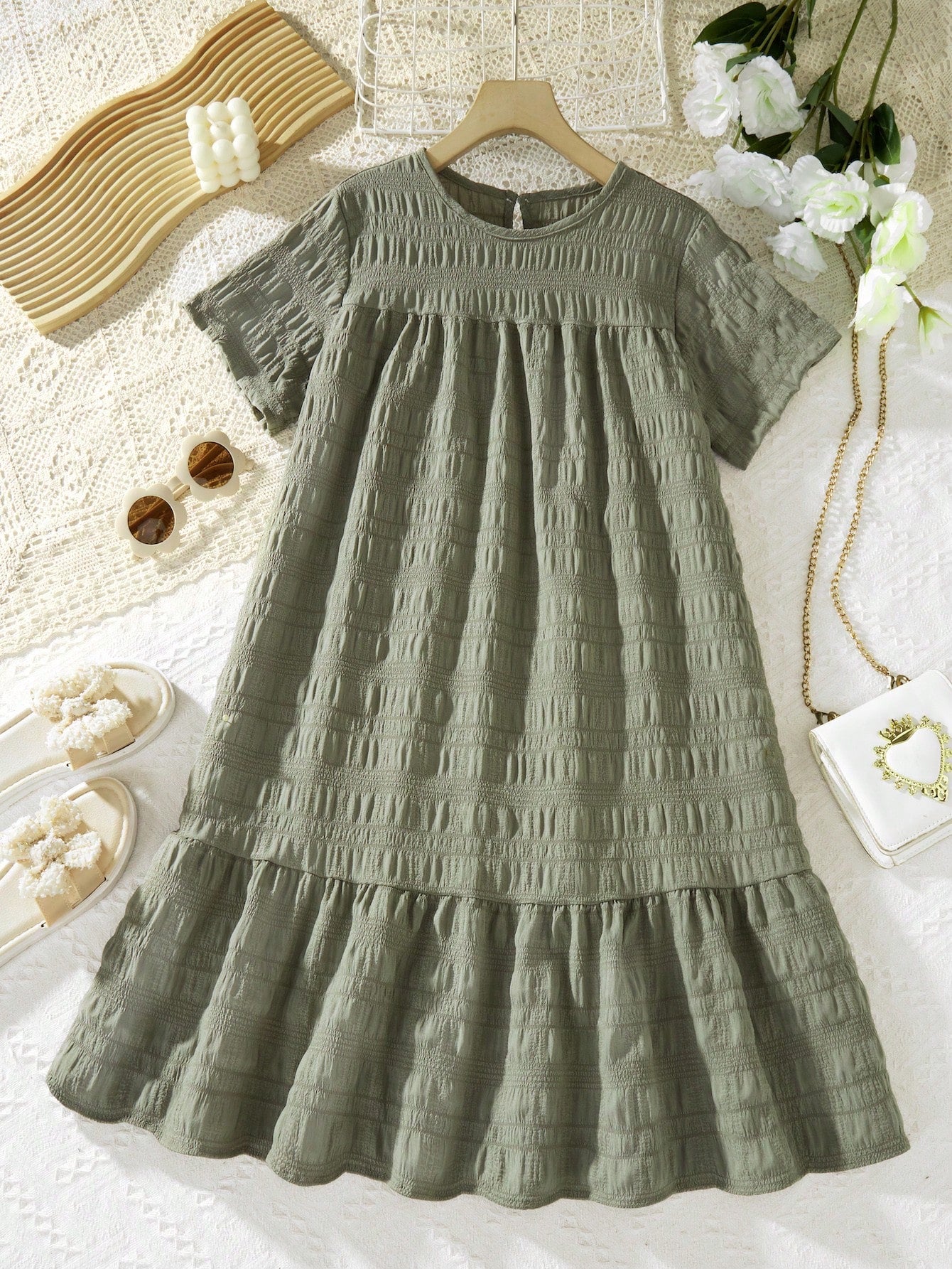 Tween girl wearing an Army Green textured short sleeve smock midi dress with round neck and ruffle flounce hem.