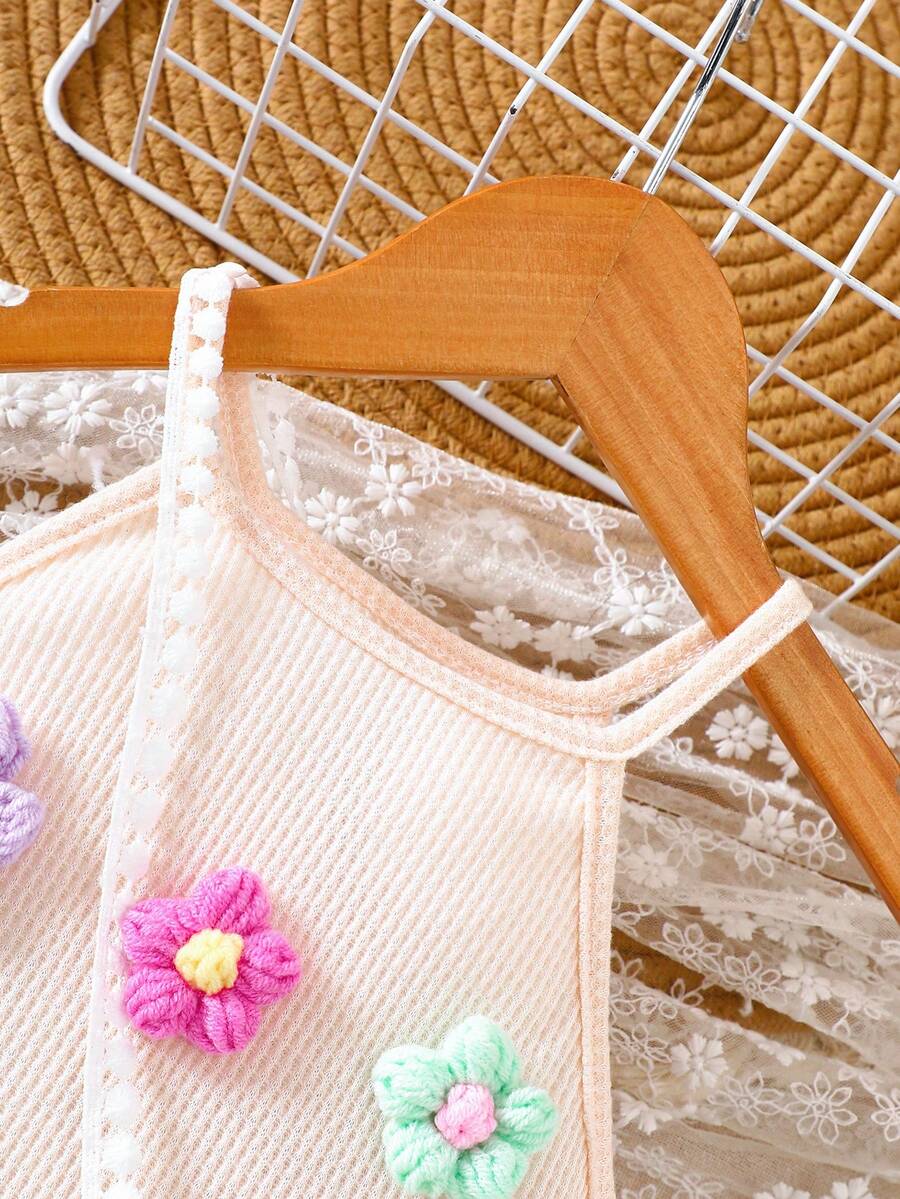 Girls' sleeveless summer midi dress with halter neckline, geometric pattern, applique and fringe details, shown with crossbody bag accessory with tassel decor
