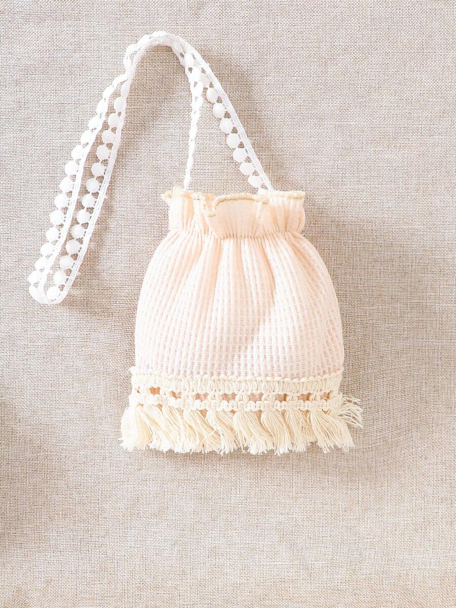 Girls' sleeveless summer midi dress with halter neckline, geometric pattern, applique and fringe details, shown with crossbody bag accessory with tassel decor