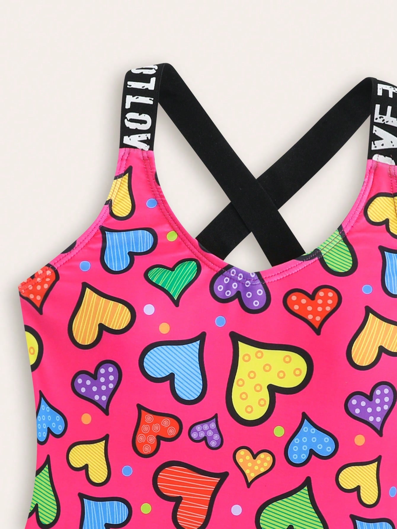 Baby pink girls one-piece swimsuit with ruffle detail, scoop neck, all-over print, and medium-stretch fabric for kids' beach and pool wear.