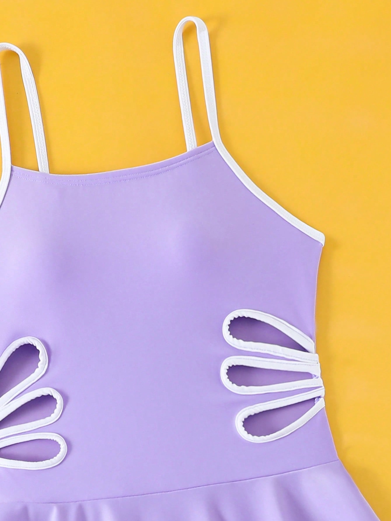 Tween girls black two-piece tankini swimwear set featuring a spaghetti strap sleeveless top with cutout detail and contrast piping, paired with short swim shorts.