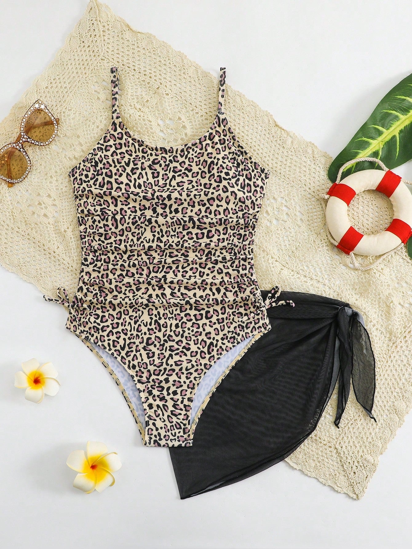 Tween girls 2-piece swimsuit in black with pink floral print, featuring spaghetti straps, bow decor, mesh detail, and a skirted mid-waist bottom. Sleeveless vacation-style swim set with medium-stretch fabric.