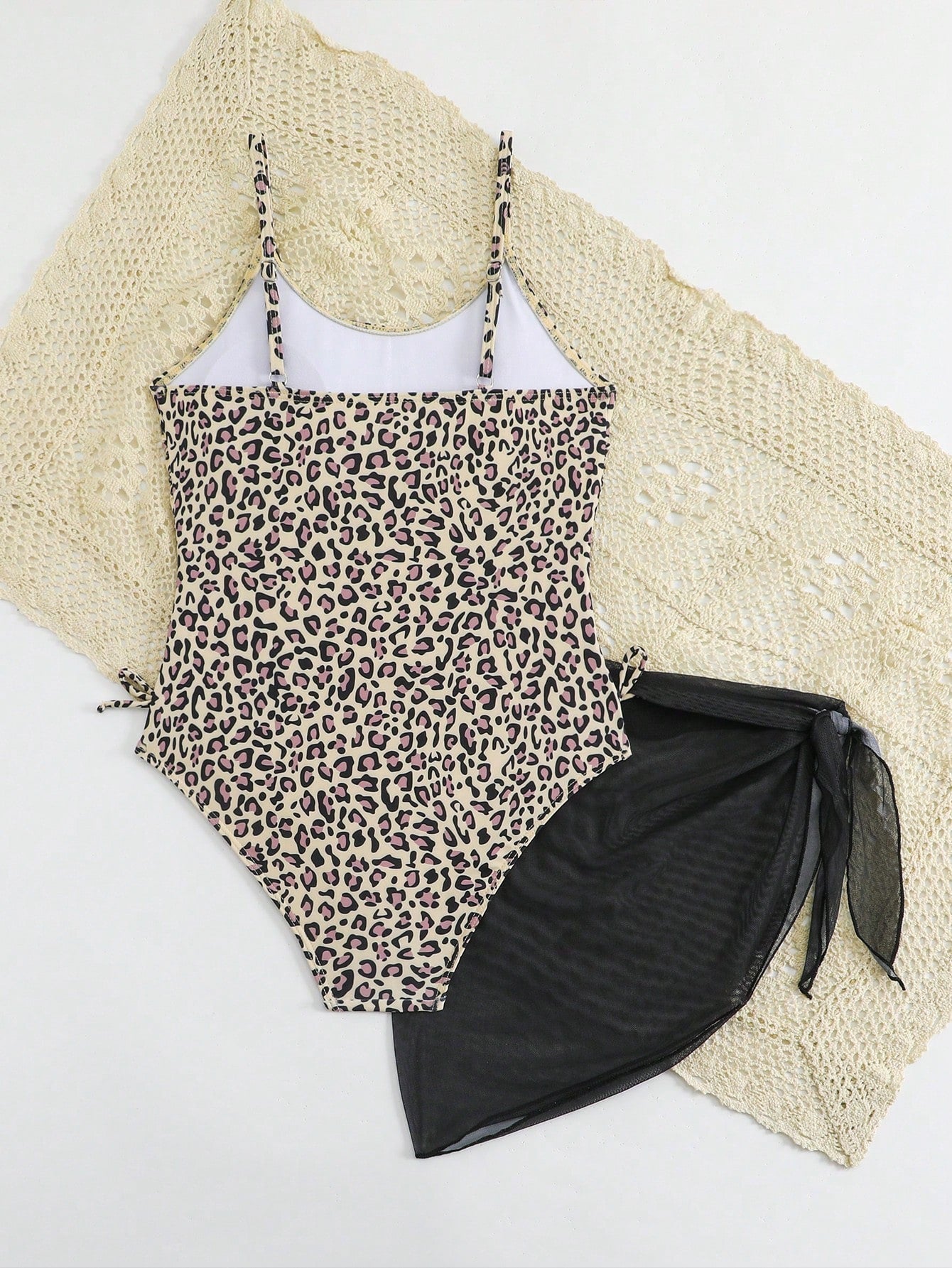 Tween girls 2-piece swimsuit in black with pink floral print, featuring spaghetti straps, bow decor, mesh detail, and a skirted mid-waist bottom. Sleeveless vacation-style swim set with medium-stretch fabric.