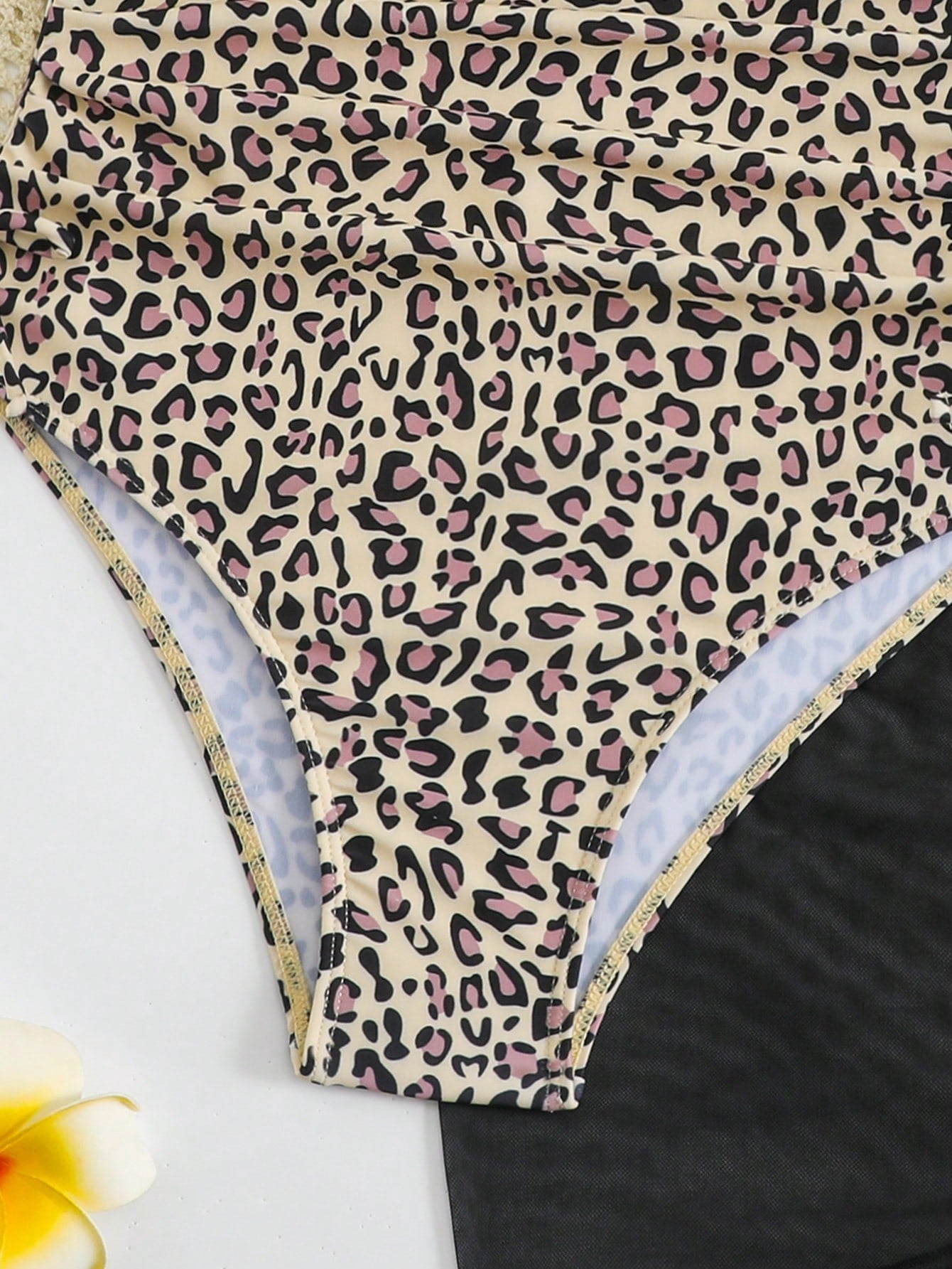 Tween girls 2-piece swimsuit in black with pink floral print, featuring spaghetti straps, bow decor, mesh detail, and a skirted mid-waist bottom. Sleeveless vacation-style swim set with medium-stretch fabric.