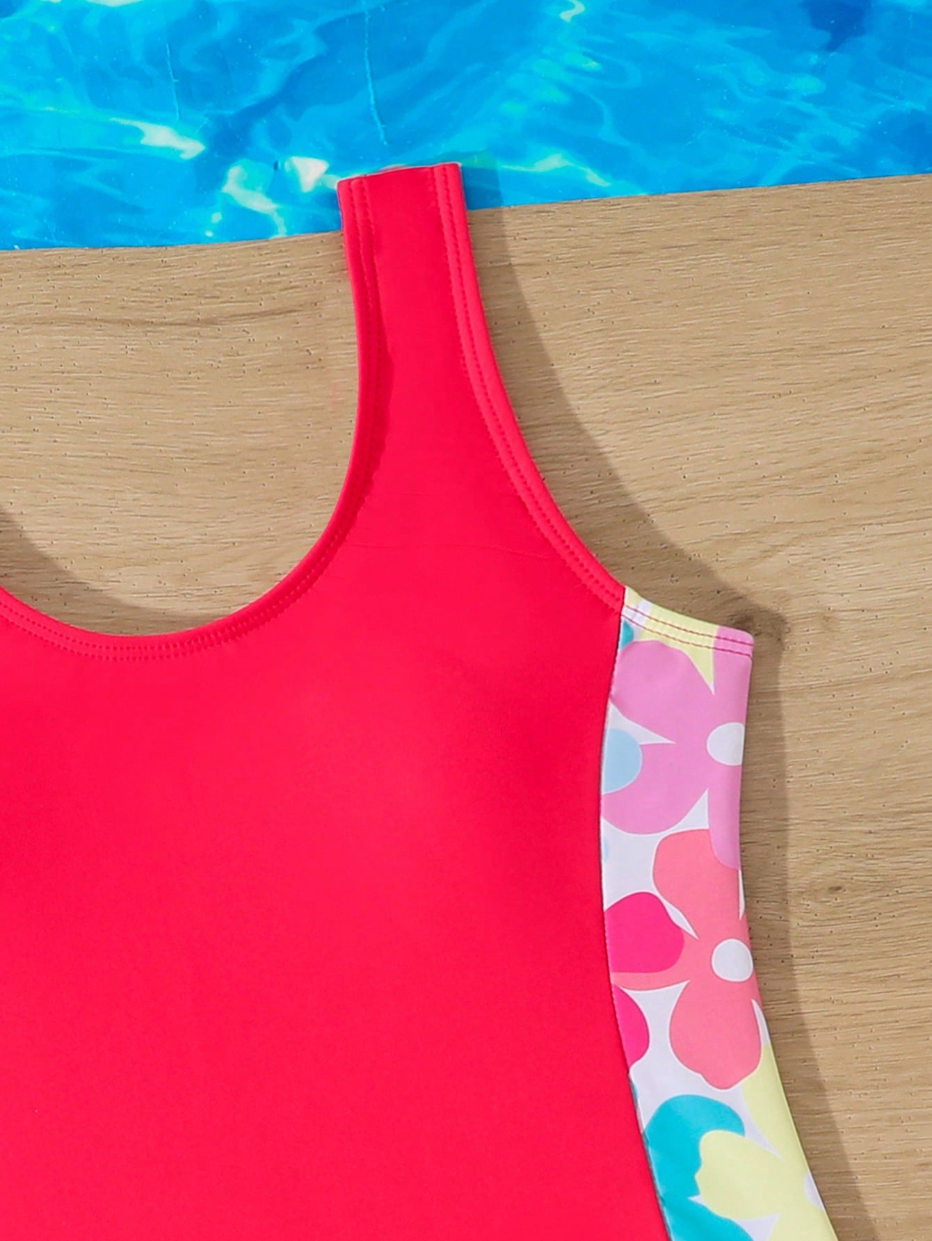Tween girls 2-piece swimsuit set in black with full floral and plant print, featuring a sleeveless scoop-neck swim top and matching shorts-style bottoms.